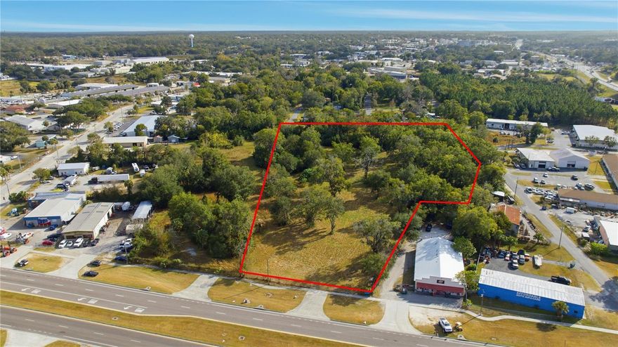 An exceptional commercial development opportunity awaits on this 4.74-acre B5 (Heavy Business) zoned property, strategically located less than 1.5 miles from Downtown Ocala. This site offers a rare combination of visibility, access, and development readiness in one of Marion County’s fastest-growing commercial corridors. With road frontage on three sides, the property provides outstanding accessibility for customers, employees, and commercial traffic, as well as multiple options for circulation, ingress, and egress.

The land is mostly cleared, creating a flexible foundation for a wide range of commercial, industrial, distribution, or flex-use applications. All major utilities are accessible along both the north and south sides of the property, significantly reducing upfront development work and broadening the possibilities for design and site planning. Utilities include electric, water, sewer, and telecommunications, allowing future owners to streamline both vertical construction and operational needs.

A pending site permit for a 30,000 sq ft office/warehouse facility has already been initiated, offering buyers a valuable head start toward development. These plans can be modified or redesigned to fit the specific needs of your business or project vision. Whether you’re planning a logistics hub, flex warehouse, showroom, contractor yard, office/industrial hybrid, or multi-tenant complex, this property provides the zoning and infrastructure to support it.

The seller has completed key due-diligence items including a boundary survey, topographic survey, and Phase I Environmental Assessment, adding tremendous value for investors and end users. These documents reduce risk, shorten timelines, and allow you to move confidently into the planning and permitting stages.

This corridor continues to experience consistent growth, supported by Ocala’s expanding industrial base, workforce population, and prime access to major transportation routes. The property’s close proximity to HWY 441, Downtown Ocala, major employment centers, medical hubs, and established businesses makes it an ideal choice for companies looking to expand or relocate. Its high-visibility position also allows for branding opportunities, signage potential, and strong daily traffic exposure.

Whether you are a developer seeking a promising commercial investment or a business owner searching for a location that offers both convenience and scalability, this property delivers unmatched flexibility and immediate development potential. Its combination of zoning, size, completed reports, utility access, and location make it one of the most attractive commercial land offerings currently available in the Ocala area.

Don’t miss this opportunity to secure a premium B5 site in a thriving market positioned for continued commercial growth.