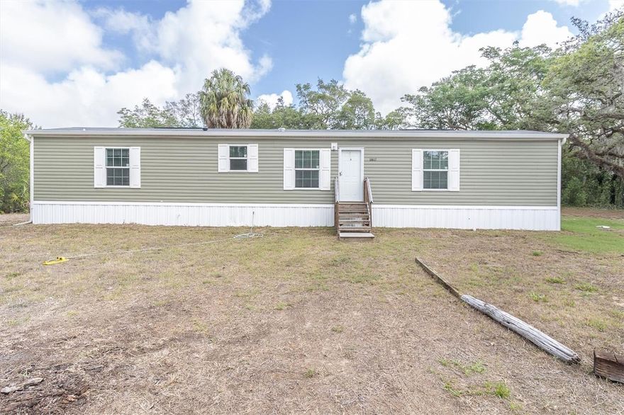 Manufactured home built in 2024 on 1.35 acres with an inground pool! Enjoy the perfect blend of modern comfort and country charm in this beautifully designed 3-bedroom, 2-bath home set on a spacious 1.35-acre lot. Step inside to an open-concept floor plan featuring abundant natural light from windows throughout and stylish laminate flooring for easy maintenance and a seamless flow. The spacious living room opens to a well-appointed kitchen complete with stainless steel appliances, ample cabinetry, and plenty of room for gathering and entertaining. The private primary suite offers a generously sized bedroom, walk-in closet, and an ensuite bath with a walk-in shower. Two additional bedrooms are thoughtfully positioned with a conveniently located second bathroom between them, providing comfort and privacy for family or guests. The laundry room, located just off the kitchen, includes a brand-new washer and dryer for added convenience. Step outside and enjoy the inground pool with patio area, perfect for relaxing, entertaining, and enjoying the Florida lifestyle year-round. Situated on the property is an additional commercial/residential building, offering endless possibilities for a home business, workshop, studio, guest space, or additional storage. With plenty of outdoor space to create your dream lifestyle, this move-in ready property combines versatility and functionality with peaceful acreage living.

A short drive away is SunWest Park, a 70-acre waterfront park offering zip lining, wakeboarding, a beach area, picnic areas, and outdoor recreation. Hudson Beach Park is also nearby, providing additional opportunities to enjoy Florida’s beautiful Gulf Coast lifestyle. Restaurants, shopping, and medical facilities are conveniently located nearby, offering everyday convenience while still enjoying the privacy and space of acreage living.