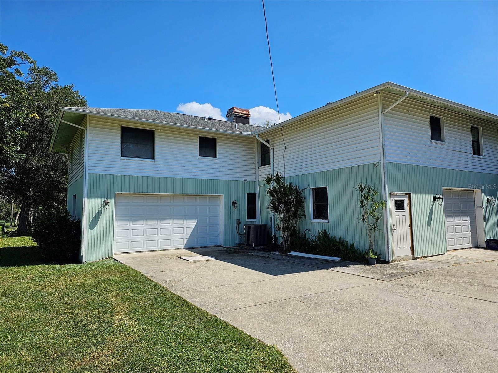 This amazing home is located in the heart of Pinellas County, and the county's best hidden secret. This property is like living in the country, right in Seminole, mid county. This is a 2 story home with the entire bottom floor a garage with 2144 sq ft. There are 2 garage doors, with room inside for up to 8 cars. The living space is the 2nd floor which has a spacious open floorplan, split bedrooms, Florida room with water views and the 1 acre lot this home sits on. With engineered hardwood floors throughout the home, interior maintenance is minimal and the home is consistent throughout. There is no carpet in the home. Downstairs under the Florida Room outside, there is a covered patio overlooking the fenced in yard. Beyond the fence is the other half of the acre, with water on 2 sides of the lot yet the house sits far back off the water. Bring your boat, jet skis, RV, there is plenty of off street and garage parking for your toys. Don't wait, this mid town oasis won't last and can be available as soon as September 1, 2025.