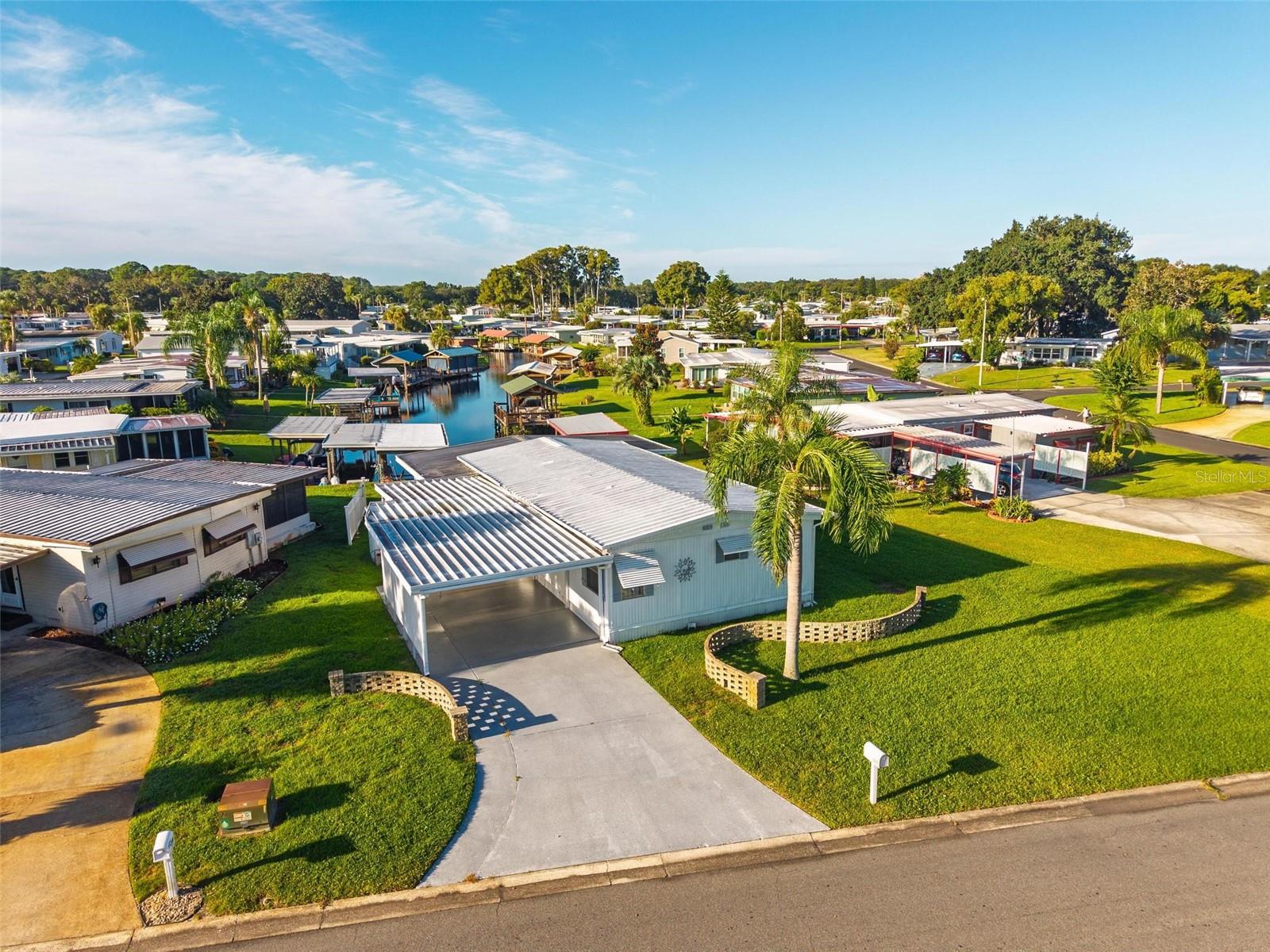 If you are looking for Florida Lifestyle Living, look no further! Discover the charm of serene canal-front living in this cozy updated double-wide manufactured home nestled within Imperial Terrace East 55+ community. Featuring LOW HOA FEES, NO LOT RENT, and a plethora of amenities including a Clubhouse, the Annex (with pool room, library and office), a screened in saltwater pool, and shuffleboard courts; this community offers both value and tranquility. This well-maintained and thoughtfully upgraded 2 Bedroom/2 Bath Canal Front Home was built in 1976 and offers 1,152 square feet of comfortable living space. It boasts a light and bright open floor plan with a spacious oversized screen Room with calming picturesque waterfront views. You will admire the fully remodeled kitchen with new appliances, countertops and luxury vinyl plank flooring. Relax and entertain on the dock and covered boathouse with a boatlift, outdoor sink and fish cleaning station. This home also offers two sheds for plenty of storage and workshop space. Imperial Terrace East is located off Hwy 441, just minutes from the best in Shopping, Dining, Entertainment, County Offices, and State-of-the-art Medical Facilities, PLUS, renowned local destinations - Mount Dora and The Villages! Easily commute to the Beach Coasts, Orlando attractions, Airports and everywhere exciting that makes Floridians love living Central in the Sunshine State, year ‘round or seasonal. This is your chance to own a waterfront retreat that balances comfort, convenience, and lifestyle-schedule your visit today!