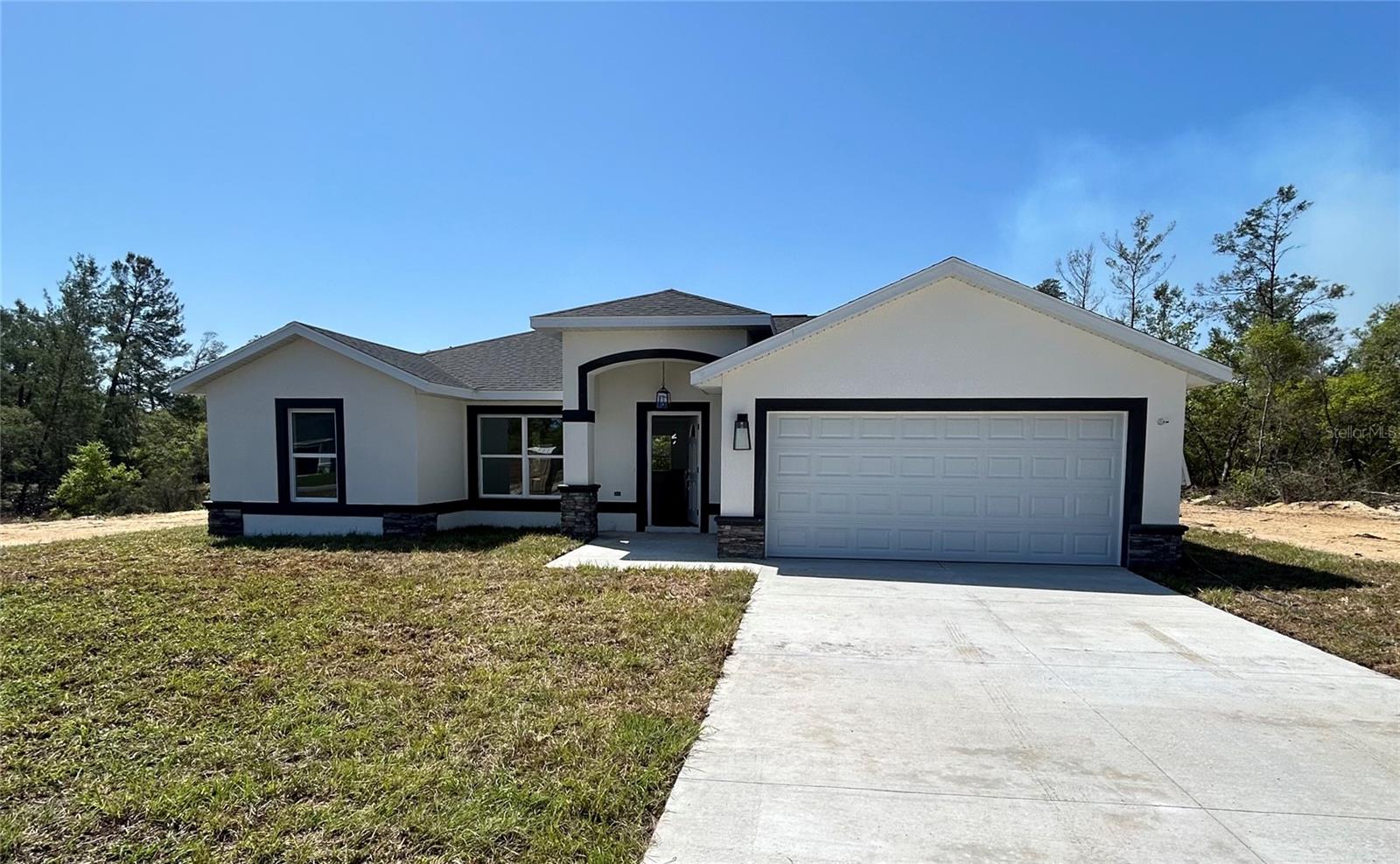 Pre-Construction. To be built. Under Construction. Introducing a stunning new construction home by Bernard Building Corp. This modern residence located at 43 Locust Run in Ocala Florida, offers 3 spacious bedrooms and 2 full bathrooms, the Bueso 2 model consists of 1,558 sq ft of thoughtfully designed living
space. The open-concept floor plan seamlessly connects the living, dining, and kitchen areas, creating an inviting atmosphere for both relaxation and entertainment. The kitchen is equipped with contemporary finishes and modern stainless steel appliances, making it a chef's delight. Additional features include a two-car garage, offering ample storage and parking space. Situated in Silver Springs Shores on a .30 Acres, this home is conveniently located near shopping, dining, grocery stores and major roadways, leading to places like The Villages area, Lady Lake and Lake Weir, ensuring easy access to all that Ocala and it's surroundings have to offer. Don't miss the opportunity to make this beautiful property your new home. Schedule a private showing TODAY!