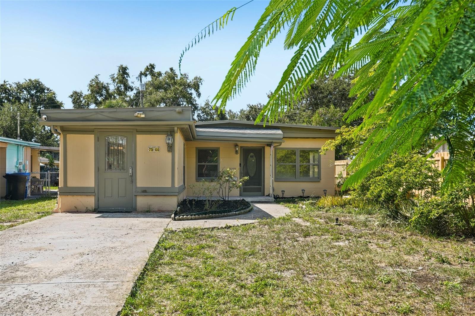 You won’t want to miss this charming St. Pete home, less than 5 miles from beautiful Madeira Beach! Featuring 3 bedrooms and 1 and 1/2 bathrooms, this home offers a smart layout with plenty of potential. The kitchen opens seamlessly to the living room, creating a bright and welcoming gathering space at the heart of the home. Tile floors and updated cabinets bring a modern touch, while the inside laundry room is conveniently located off the kitchen, adds everyday ease. Two bedrooms are tucked away at the back for privacy, while the third bedroom sits at the front with its own private entrance, perfect for guests, a home office, or even an income-producing opportunity. Step outside to a spacious, fenced backyard complete with mature fruit trees, including mango, orange, and custard apple, offering both shade and homegrown delights. With NO HOA or CDD, it’s the perfect place to bring your boat, jet ski or any other water toys. Schedule your private showing today and see the possibilities for yourself!