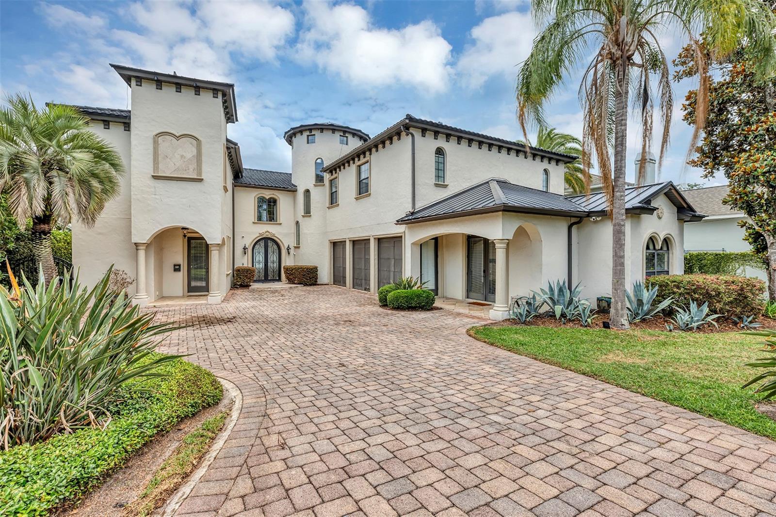 Luxury Lakefront Estate in College Park – 7,500+ Sq Ft of Elegance Discover an extraordinary opportunity to own a true masterpiece in the heart of Orlando’s highly desirable College Park neighborhood. Situated directly on Lake Silver, this 7,500 sq ft luxury estate offers breathtaking water views, resort-style amenities, and exceptional upgrades throughout. This residence features a brand-new $130,000 stone-coated metal roof (2024), 63 solar panels dramatically reducing energy costs, and 4 high-efficiency AC units (5-ton in 2024, two 2-ton units in 2022, and a 4-ton in 2019). Additional upgrades include: new sprinkler system and pump (2025), mosquito prevention system by Mosquito Nix (2022), surround sound speakers indoors and outdoors (2024), pool pumps (2022), newer hybrid water heater (2022), commercial-grade tankless water heater upstairs, and a new Monogram oven/microwave combo (2024). Enter through an impressive decorative metal door into a grand living room with a cathedral-style staircase and panoramic views of the pool and lake through expansive French doors and windows. The chef’s kitchen boasts granite countertops, extensive cabinetry, a walk-in pantry the size of a closet, gas stove, built-in refrigerator and dishwasher, pot filler, dual sinks plus additional prep sinks, and wet bars adjacent to the kitchen—ideal for entertaining. This estate features 5 bedrooms, 7 bathrooms, multiple wet bars, and a media room. Two private guest suites, each with separate driveway access, are currently used as short-term rentals, offering a valuable income opportunity. The larger suite includes a walk-in closet and bathroom, while the smaller suite features a spa style bathroom with a sauna room & a steam sauna/shower combo with direct pool access. Upstairs, enjoy a spacious landing and entertainment area with a side balcony overlooking the lake. Additional highlights include mirrored bedrooms with en suite baths, a media room with half bath and balcony, an arcade room, and upstairs laundry (with a second laundry downstairs). An elevator shaft is pre-fabricated for future installation. The primary suite is an expansive retreat, with two enormous walk-in closets, a wet bar, private balcony, and a spa-like bathroom featuring a soaking tub, walk-around shower with dual water features, dual vanities, and a balcony overlooking the pool and lake. The resort-style backyard showcases a lagoon-inspired pool with water features, a swim-under bridge to the hot tub, lush tropical landscaping, and a custom $30,000 Haven Lighting system offering programmable colors and designs. A private dock with boat lift provides direct access to Lake Silver, a private ski lake in the heart of Orlando. This home seamlessly blends modern luxury, comfort, and function, making it one of the most remarkable properties in Central Florida. Schedule your private showing today to experience the luxurious lifestyle of living lakeside in the Downtown Orlando Area.