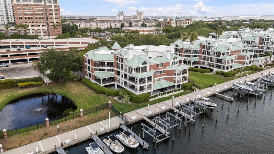 Welcome to elevated waterfront living in one of Tampa’s most exclusive enclaves. This stunning 2-bedroom, 2.5-bath condo at 707 Seddon Cove Way is nestled within the prestigious 24-hour guard-gated community of Harbour Island, offering both privacy and convenience in the heart of the city.

Step inside and immediately notice the warmth of rich parquet wood flooring complemented by elegant marble accents, creating a sophisticated yet inviting atmosphere. The spacious living area is anchored by a charming wood-burning fireplace—perfect for cozy evenings—and flows seamlessly out to the largest covered lanai in the building. From here, enjoy breathtaking water views, including a serene pond to the right, making it an ideal space for relaxing or entertaining.

The kitchen comes fully equipped with all appliances, including an in-unit washer and dryer and a brand-new wine refrigerator—perfect for hosting or unwinding after a long day. Fresh paint throughout and a newly updated bathroom vanity add a crisp, modern touch.

This well-maintained community has recently undergone significant upgrades, including new roofs and elevators, ensuring peace of mind for years to come. Residents also enjoy access to a sparkling community pool and beautifully landscaped surroundings.

Location is everything, and this condo delivers. Just steps away, you’ll find yourself within walking distance of Tampa’s most vibrant destinations, including Water Street, the Tampa Convention Center, the Riverwalk, and Davis Islands. Whether you’re seeking fine dining, entertainment, or outdoor recreation, it’s all right at your doorstep.

This is more than a home—it’s a lifestyle. Don’t miss your opportunity to own a piece of paradise in Harbor Island.