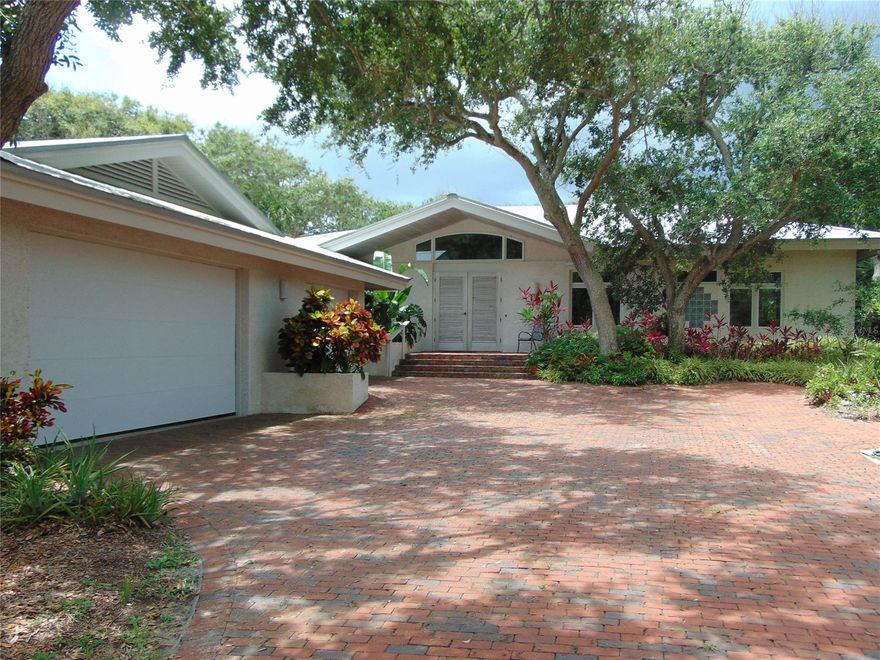 Contemporary north beach intracoastal frontage home.  This Chris Frank designed residence has been meticulously cared for throughout the last twenty-three years by the original owners. This intimate home sits upon a large 100' river front lot with high elevations. This home's construction quality has an exceedingly improved foundation capable of easily carrying the weight of a second story with solidly poured exterior columns. Wet plaster finishes, pickled solid core interior doors/ trim and double pane Anderson windows are just a few of the upgrades in this custom home. This solidly built home is protected by thick tabby stucco exterior finishes that accentuate its island theme.  The oversized garage measures 37'4 X 36' which easily accommodates 5+ automobiles in tandem fashion. The well maintained dock with 100 amp dedicated service supplies power to the large boathouse with a 13,000 lb. lift and the additional 4500 lb. lift as well.  Beautiful sunsets are a nightly occurence and all manner of wildlife entertain in the river and in estuary to the west. Easy access to Mosquito Lagoon. One mile(10 minutes) to the Inlet by watercraft, no wake zone and no fixed bridges to contend with; this is truly a "boaters" home!  Properties like this don't come up often, and when they do, whoever is smart enough to grab will have a lifetime of memories there.  It's that special.  Watch the video  https://youtu.be/gCv6YUDr6xs ;Water: City