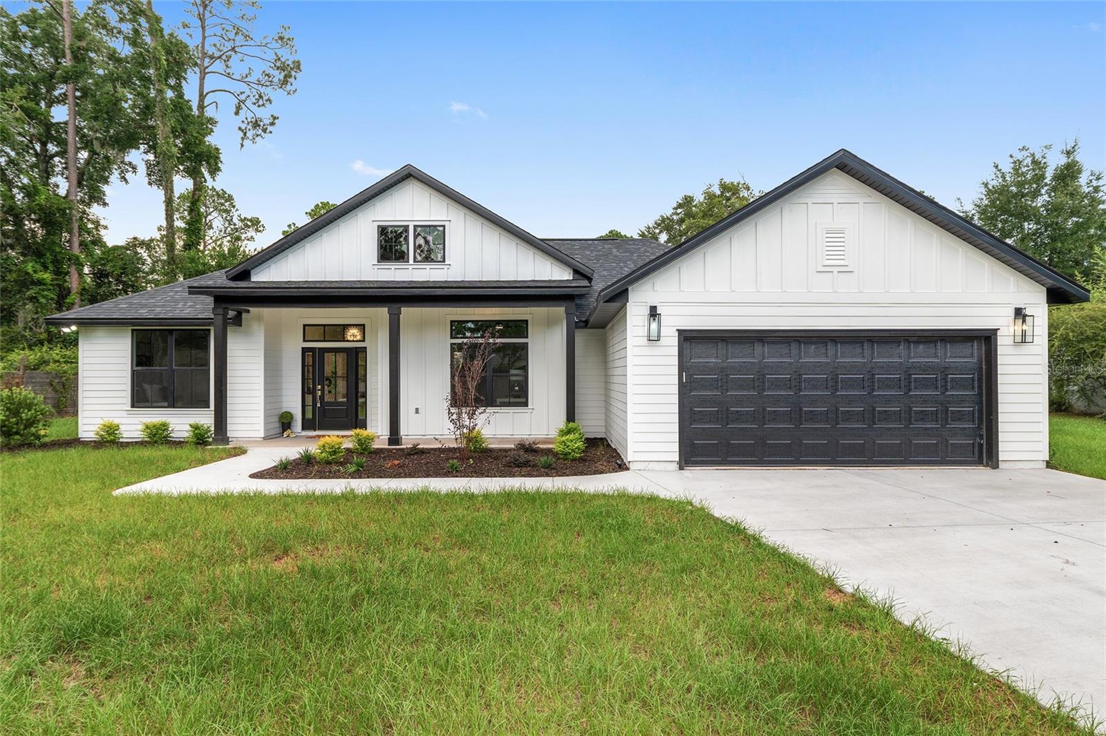 This stunning new construction home by Elevated Design & Construction blends bold design with modern comfort in the heart of Suburban Heights. With 4 bedrooms and 2 bathrooms, this custom-built home showcases a striking black-and-white palette, 10-foot ceilings, and an open layout that feels both spacious and stylish. From the moment you enter through the 8-foot doors, you'll notice premium features like rich 20 mil LVP flooring, designer lighting, Italian porcelain tile in the bathrooms, and bold accent walls that add personality throughout. The sleek kitchen is equipped with quartz countertops, a custom sink, two-tier glass-accent cabinetry, and upper and lower cabinet lighting. A 72-inch fan anchors the main living area, while 52-inch fans in each bedroom enhance comfort. The primary suite offers a peaceful retreat with a large soaking tub, a glass-enclosed shower, and elevated finishes throughout. Step outside to a covered back porch overlooking a wooded backyard, ideal for relaxing or entertaining. The fully sodded yard is professionally landscaped, treated with Bug Blaster for a healthy lawn, and enhanced with landscape lighting to create a warm, welcoming ambiance. This is not your average new build — a distinctive home that combines high-end finishes with thoughtful, design-forward touches throughout!