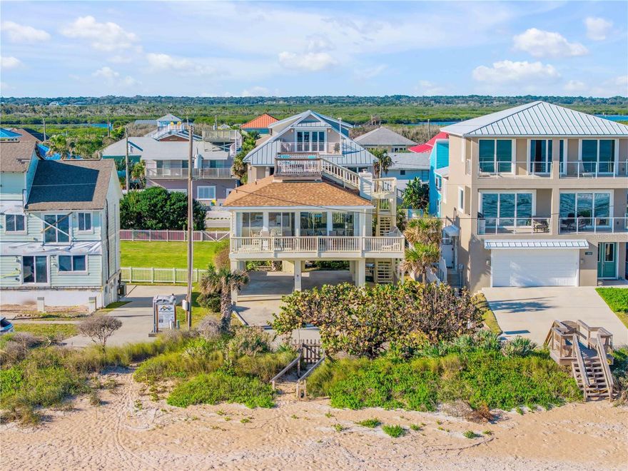 Wake up to glowing ocean sunrises in Bethune Beach, one of New Smyrna Beach’s most cherished coastal communities. This direct oceanfront two-bedroom, two-bath home features an east-facing design that captures sweeping Atlantic views from every main living space. Wall-to-wall sliding glass doors span the living room, dining area, and kitchen, creating a stunning 180-degree ocean backdrop and opening to a wraparound covered deck where sea breezes become part of daily life. Inside, the home offers a spacious living room with cozy fireplace, kitchen and dining area with eat in bar and a flexible layout ready for your personal updates. 2 bedrooms each with their own attached en-suite baths offers comfort and privacy.  Lots of closet space and built in laundry as well. Recent improvements provide peace of mind, including a new roof in 2024 and a new HVAC system in 2025. Above it all, an oversized sky deck delivers elevated views of both the ocean and the estuary—ideal for sunrise mornings, sunset evenings, or quiet moments under the stars. Parking is effortless with an oversized covered carport and a spacious driveway for guests. Your very own personal and private beach access is just outside your door. And you’re conveniently close to the Canaveral National Seashore, JB’s Fish Camp, and the shops and restaurants of Flagler Avenue and Canal Street. This Bethune Beach home presents a rare opportunity to create your own oceanfront retreat in a truly special setting.