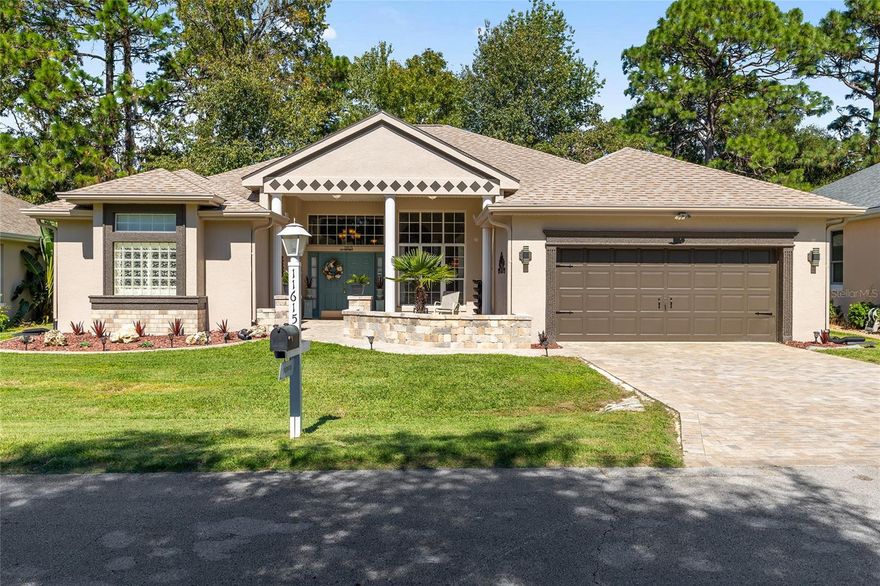 BIG, BOLD and BEAUTIFUL! Just the curb appeal will MAKE YOU STOP THE CAR!! Brand NEW BIG PAVER DRIVEWAY and NEW Brick Paver Courtyard Wall to enhance your privacy on the Large quite expansive FRONT PORCH! Open the front door to WOW! OPEN FLOOR PLAN with a view to the Golf Course from the front door through to the living room, family room, Master Bedroom and Guest bedroom.  Plantation shutters in Master bedroom, master bath, bedrooms.Living room boasts a gas burning COZY FIREPLACE. Kitchen is fantastic with standard counter height countertops - no trying to get into those tall bar stools.  GORGEOUS GRANITE COUNTERTOPS and BACKSPLASH, Stainless Steel Appliances, Under and Over cabinet lighting, center island, PULL OUT DRAWERS and CLOSETS GALORE! The kitchen opens up to Family Room or you can use this space as a dining room and the same with the dining room you can use it as a Family Room.  All rooms have been modernized with high end CROWN MOLDING, Newer ceiling fans and light fixtures.  The HUGE Luxurious MASTER BEDROOM will take your breath away with 2 walk in closets, an on suite bathroom that says "Calgon take me away". It boasts a  Crystal Chandelier, State of the Art, top of the line Walk in tub, step in shower and his and her vanities. Indoor laundry with cabinetry off of the kitchen. NOW wait til you feast your eyes on the LANAI that has been enhanced with insulation and HEAT and Air and the view is just SPECTACULAR! And let's not forget that BODACIOUS 588 sq ft GARAGE that can accommodate 2 cars and a golf cart plus with high ceilings, there is plenty of room to add extra storage space.  House was painted on the outside in August 2025, Roof replaced in 2020, AC 2018, whole house surge protector and a new water softener too! Not only does this house have a GOLF COURSE VIEW it's just around the block from the Golf Course, Restaurant, Fitness Center, Auditorium, Pool and jacuzzi. So what are you waiting for? Don't you deserve the life of luxury? Don't you deserve to treat yourself to a beautiful home on the Golf Course in a community that offers so many amenities and is located close to shopping, restaurants, medical facilities and has over 50 clubs, pickleball, tennis, bocce ball, shuffleboard, library, billiards room 6 pools, 5 hot tubs, Dog Park, BINGO and MORE!! - I'm sure you will find your place here in the Florida Sunshine today!