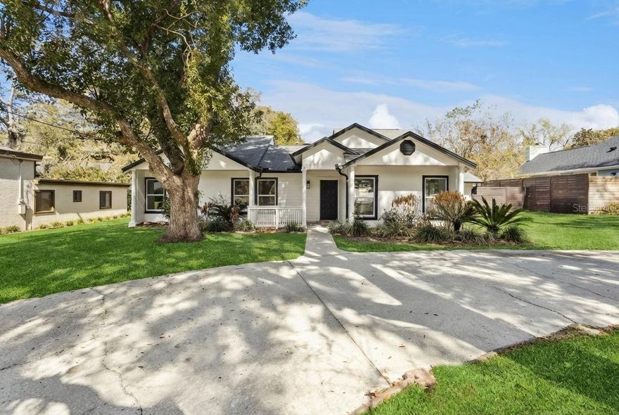 Tucked beneath a canopy of mature trees, where the road gently rolls—yes, real hills in Central Florida—407 Forest Road captures the rhythm of life in Mount Dora, a storybook lakefront town known for its charming streets, vibrant arts scene, and year-round festivals that bring neighbors together like family reunions. Here, you’re perfectly positioned between two worlds of water. A short stroll leads you to the peaceful shoreline of Lake Gertrude—a serene, non-motorized lake ideal for kayaking at sunrise, paddleboarding at dusk, or quiet evening walks beneath oak-lined paths. Around the corner awaits the adventure of the Harris Chain of Lakes, offering boating, waterfront dining, and access to over 30 public boat ramps, including beloved Gilbert Park. Whether you prefer still waters or open throttle, this address lets you choose your pace. And when you’re ready for cobblestone sidewalks, boutiques, and café patios, historic downtown Mount Dora is just minutes away. Nestled on over a quarter of an acre this renovated three-bedroom, two-bath residence offers adaptability, featuring a BONUS room with its OWN PRIVATE ENTRANCE and double glass French doors—ideal for a home office, in-law suite, or guest retreat. The inviting front porch overlooks the circular driveway and gently rolling roadway, a rare Florida setting. Inside, luxury laminate flooring flows throughout, complemented by modern recessed lighting and energy-efficient remote-controlled ceiling fans in every bedroom, the bonus room, and main living areas. A classic whole-house ventilation fan provides an energy-saving cooling option. The formal living area is anchored by a stone wood-burning fireplace, with a barn door leading to the bedroom wing. The updated kitchen showcases brand-new stainless steel Samsung appliances, quartz countertops, and a generous quartz island with ample seating. Soft-close engineered wood cabinetry and floating luxury shelves enhance both style and function. An expansive sliding pass-through window above the sink frames pool views and opens to the covered patio for seamless indoor-outdoor entertaining. While the dining area features a unique window seating nook adding a touch of charm and tranquility, an inviting space to relax and simply enjoy the views of the natural light.  The primary suite features a spa-inspired bathroom with black-framed sliding glass shower doors, matte black fixtures, warm wood-look tile in the oversized walk-in shower, glossy tile flooring, and ample closet space. The shower opens to a private outdoor wood deck perfect for sunbathing and relaxation, while double French doors lead to the covered patio and pool. The fully fenced backyard offers a six-foot-deep saltwater pool, covered patio with pavers, rock waterfall feature, storage shed, NEW irrigation system with timer, and a brand-NEW POOL WATER PUMP & SALT WATER SYSTEM. Additional major upgrades include a NEW AC/HVAC system, a 2017 roof, a 2023 water heater & BRAND NEW WINDOWS throughout the entire property! 407 Forest Road isn’t just a renovated home—it’s a lifestyle address where lake mornings, festival weekends, porch sunsets, and poolside gatherings become part of your everyday rhythm. In Mount Dora, life moves a little slower, shines a little brighter, and feels just right.