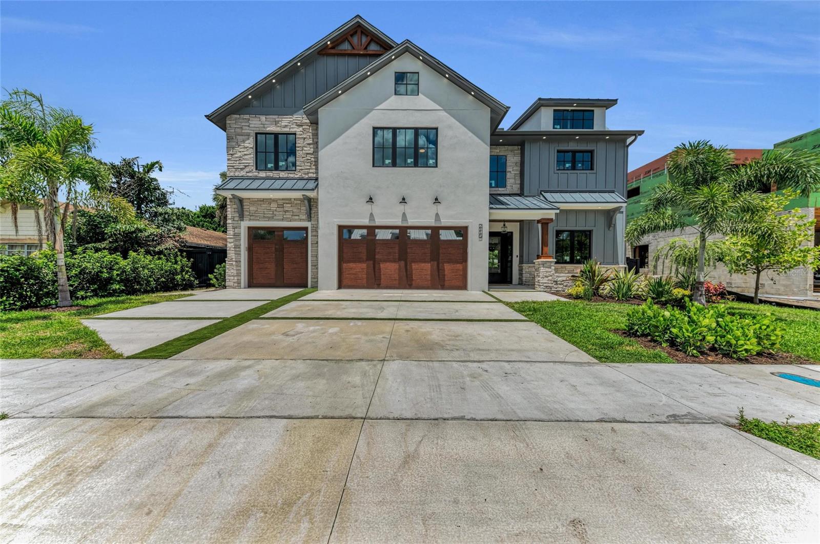 Nestled in the heart of Sarasota, this modern farmhouse offers a perfect blend of contemporary luxury and southern charm. Boasting 4 bedrooms, 3.5 baths, an office space, extra-large pool, private backyard oasis and a spacious 3-car garage, this residence is thoughtfully designed for the ultimate in comfort and style. The interior of this modern farmhouse is designed with meticulous attention to detail, showcasing an open-concept floor plan that seamlessly connects the living, dining, and kitchen areas. Each bedroom features its own walk-in closet with the primary bedroom featuring two of its own. Elegant finishes, tile floors, and large windows create a bright and inviting atmosphere throughout the home. The gourmet kitchen is a chef's dream, featuring high-end appliances, custom cabinets, quartz countertops, a separate bar area, and a spacious extra-long island. It is perfect for culinary enthusiasts and those who love to entertain. The expansive master suite provides a serene retreat with a grand fireplace and separate reading and relaxing area, a luxurious en-suite bathroom, complete with a freestanding soaking tub, a walk-in shower with multi-faucets, and dual vanities. Large windows breathtaking views of the surrounding landscape. Step outside into your own private paradise, where the backyard gazebo steals the show. Its covered design ensures comfort rain or shine, while a retractable sun shade offers protection from the elements, allowing you to enjoy every moment, whether it's a sunny day, a breezy evening, or a rainy afternoon. Prepare your favorite bites in the outdoor kitchen, sip cocktails at the bar, and catch the big game on the outdoor TV. The large pool provides a refreshing escape, surrounded by lush landscaping and a spacious patio for lounging. Situated in the vibrant city of Sarasota in the coveted neighborhood of Arlington Park, blocks from Sarasota Memorial Hospital and minutes from downtown, you'll have easy access to the best the Gulf Coast - from world-class beaches to cultural attractions and fine dining. Don't miss the opportunity to make this exceptional modern farmhouse your own. Contact us today for more information on the property.