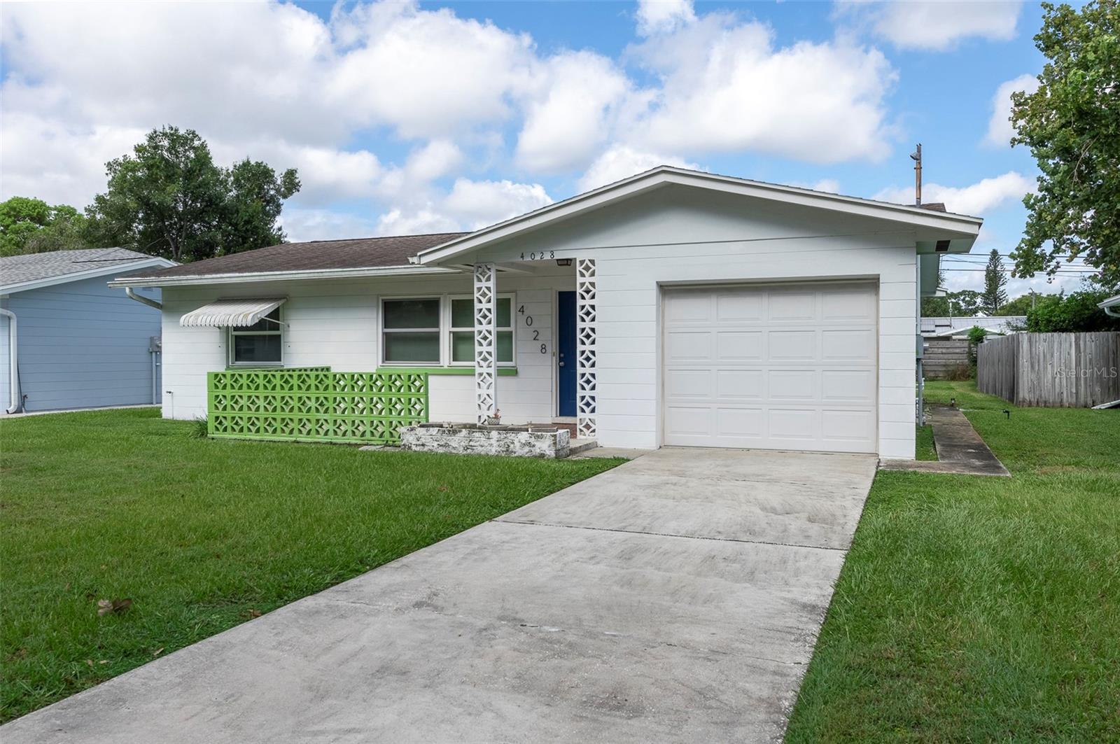 Welcome to this high and dry home, ideally located near everything St Pete has to offer. This attractively priced solid block two bedroom, one bath, one car garage home has more than good bones, it has updated ones. The A/C was replaced in 2023, along with a new water heater. In addition the roof is less than ten years old, and the windows have all been replaced with impact rated insulated PGT windows. The washer/dryer is new and state of the art. The panel box is updated along with a hurricane rated garage door. The expensive updates are done, allowing a new owner cash to update other items. The floors are an attractive style of terrazzo, which can be refinished. The kitchen and bath are the retro 60’s look, which some buyers choose to keep. The divider between the kitchen and dining could be removed, with the result being an open floor plan. This home has potential, and would make a great starter home. It is only a half a block from Kiwanis Park with a playground and exercise stations, and less than a mile from I275. One can be downtown in less than ten minutes. A quiet location, strong bones, at a compelling price. See it today!