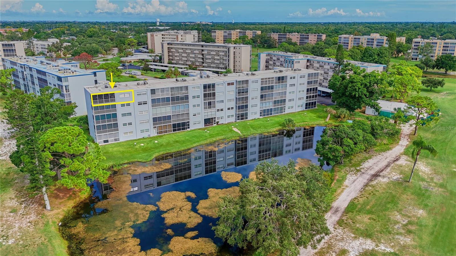 Every now and then, an exceptionally transformed home in a rare location comes along that rivals all others! Welcome to this awe-inspiring, END UNIT on the TOP FLOOR of the coveted Building G in the Ironwood community! Here, the panoramic views are extra special because the glass-enclosed lanai extending 'around the corner' which gains an additional glass wall of tropical views that can be seen from most rooms in the condo. You'll experience gorgeous sunsets over the West-facing, pond views on the golf course. You'll appreciate the professionally applied, 3M lifetime sun film applied to the massive glass doors on the lanai which significantly reduces the heat, yet preserves the bright, clear views (a $3200 upgrade). Enjoy the open floor plan from this stunning, open kitchen with its generously-sized quartz countertop that incorporates barstool seating. You can't miss the plethora of premium updates and craftsmanship that grace this home: Top-tier, commercial-rated, luxury vinyl flooring with "silent floor" underlayment, real wood, kitchen cabinetry that extends to the ceiling and includes custom storage appointments, high end-Frigidaire "Gallery Series" appliances (2024), to name just a few. Both bathroom have renovations include new vanities, new toilets, and quality fixtures and lighting; The main bath renovation includes a complete shower update with stunning porcelain tile. A permit-obtained-shower pan and new drain pipes were also done. Recessed LED lighting, new lighting fixtures and fans, complement the modern, coastal aesthetic throughout (see attachment for comprehensive list of updates). The A/C was replaced in 2022.  You'll have even greater peace of mind knowing the seller has already paid the assessment in full which will cover a new roof when needed in upcoming years.  Enjoy the unique advantage of owning carport #29 - covered parking that is quite close to elevator; Each floor has its own laundry facilities and is conveniently located near the elevators - steps away from this corner condo. An additional storage unit, handy for seasonal items, bicycles, etc., is also on the same floor. Ironwood is known for its resort-style living, rich with on-site amenities including: 18 Hole Golf Course (Membership is Not Mandatory), Heated Pool, pickleball, tennis courts, Fitness center, Billiards, scheduled activities, Dance floor and Shuffleboard. It's a few minutes drive to groceries, shopping, banks, movies, medical facilities, churches, and GT Bray Sports Complex. Best of all, Ironwood is only 6.5 miles from Award-winning beaches, including Anna Maria Island. While there has been a longstanding 'No dogs' policy that is currently in place, HOA board discussions have been underway for possible changes in the future that would include canine friends of the smaller kind. Cats are welcomed. Come see the incomparable value for yourself, today, and schedule your showing for this exquisite, end condo of the penthouse floor of Building G!