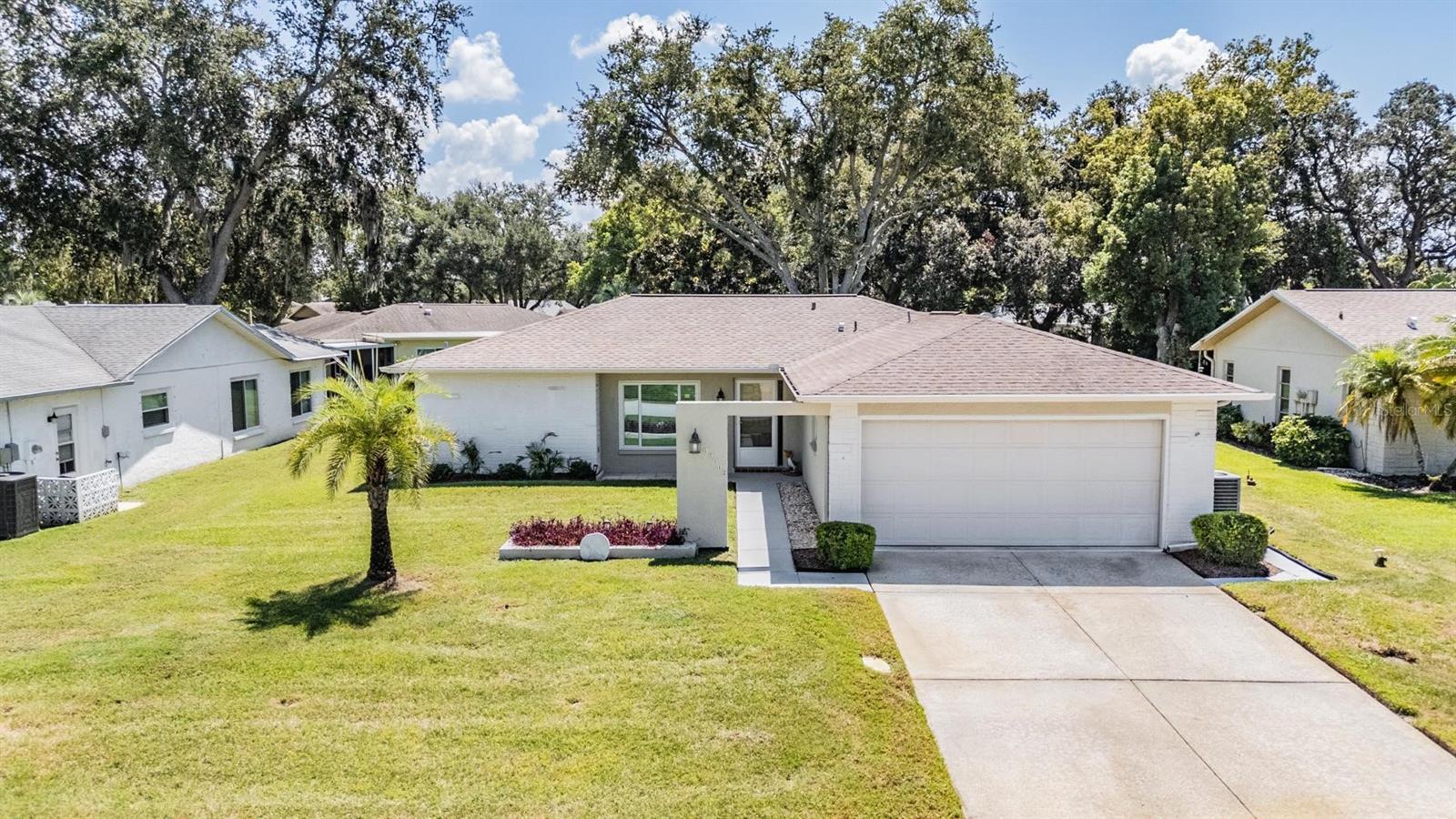 MINT MINT MINT! IMMACULATE 2 BEDROOM, 2 BATHROOM WITH BONUS ROOM AND SCREENED IN BACK PORCH IN TIMBER OAKS! *BRAND NEW ROOF WILL BE INSTALLED BEFORE CLOSING!* This home has been meticulously cared for! This kitchen is spacious, bright, and overlooks the bonus room and back yard! The primary Bed/bathroom features a walk-in closet, walk-in shower, and a high vanity with Corian top! The 2nd bedroom is across the house and close to the 2nd bathroom which has a new shower surround and tall vanity topped with Corian! The laundry room is also spacious and equipped with a utility sink and cabinets! The bonus room and screened-in back porch overlook the open lawn in the back, providing a relaxing area to unwind! The Bonus room is climate controlled for relaxation through all seasons! Other features of this home include its newer windows, Newer laminate flooring, and ceiling fans in all rooms! All of this in the beautiful 55+ community of Timber Oaks which includes its heated 24hr community pool, hot tub, and clubhouse that all over look a beautiful lake! Low HOW Fee at just $55/month! *New roof comes with a transferrable warranty!