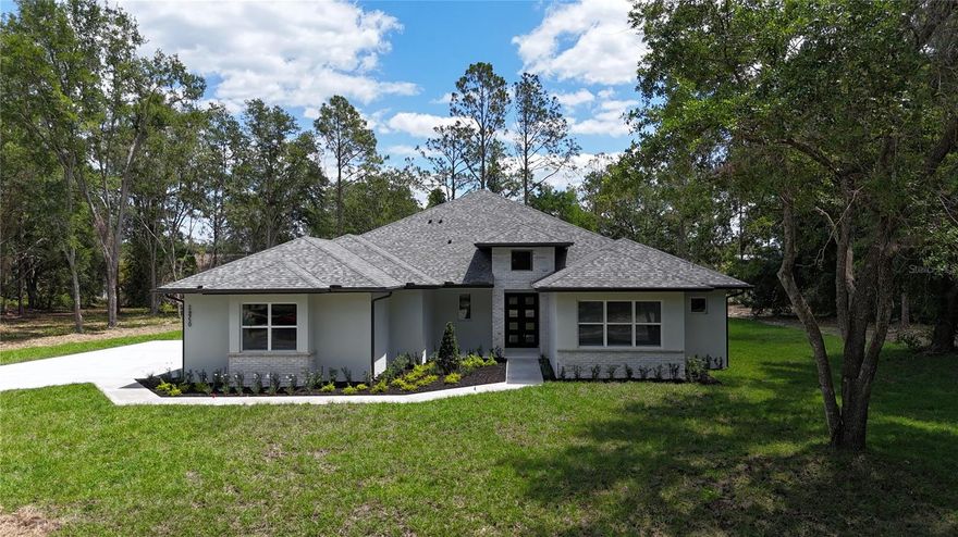 Discover elevated living in this stunning new construction home located at 24950 Bonsmara Dr in Groveland, FL. Nestled on an expansive 1.05-acre lot within a peaceful gated community, this 4-bedroom, 3.5-bath residence offers the perfect blend of luxury, comfort, and modern design.

Step inside to an inviting open floor plan featuring soaring 10-foot ceilings, LED lighting, and elegant finishes throughout. The spacious living area flows seamlessly into a chef-inspired kitchen complete with quartz countertops, marble backsplash, stainless steel appliances, a large island, walk-in pantry with outlets, and a wine/beverage fridge—perfect for entertaining. A cozy breakfast nook and formal dining room with double French doors open to a charming breakfast porch, bringing in natural light and serene outdoor views.

The luxurious primary suite is a private retreat, boasting a spa-like ensuite bath with dual vanities, a soaking tub, and a spacious walk-in shower. Dual custom walk-in closets—including a reinforced safe room—add both style and security. Additional bedrooms are generously sized, and a flexible 4th room can serve as a home office, study, or library.

Designed for both indoor and outdoor living, the home features a covered patio prepped for an outdoor kitchen, a welcoming front porch, professional landscaping, irrigation system, and ambient outdoor lighting. The 3-car garage, mudroom, and a well-appointed laundry room with built-in cabinetry add everyday convenience.

Premium upgrades include rigid core luxury vinyl flooring, spray foam insulation for energy efficiency, a 200-amp transfer switch, water softener with sulfur filtration system, and a custom handcrafted iron front door that makes a bold first impression.

Located in an exclusive 87-lot gated community, residents enjoy access to amenities such as a tennis court, pickleball, and a scenic fishing dock on Clearwater Lake. Conveniently close to local schools, yet surrounded by nature and wildlife, this home offers the best of both privacy and accessibility.

With over 3,100 sq ft of living space and nearly 4,700 total sq ft, this exceptional property delivers luxury living at its finest.