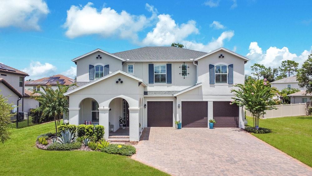 Welcome home to this stunning modern residence in the private, gated Lakeshore of Wekiva community. Built in 2020, this 3,663 sq ft open-concept home features 5 bedrooms, 4 bathrooms, a 3-car garage, and a versatile second-floor loft. Soaring ceilings make a dramatic statement in the great room, while the gourmet kitchen boasts stone countertops, a spacious island, a walk-in pantry, and premium finishes throughout. The luxurious primary suite is a serene retreat on the second floor, offering a spa-inspired bathroom with a large walk-in shower and an oversized walk-in closet. Upstairs, you’ll also find three additional bedrooms—each with its own walk-in closet—providing ample space and comfort. A fifth bedroom or flexible office space is conveniently located on the first floor. Step outside to your private backyard oasis, complete with a screened pool, expansive paver patio, fully equipped outdoor kitchen, covered pergola, lush landscaping, and a fenced yard—perfect for relaxing or entertaining. Additional upgrades include a gas stove and water heater, enhanced lighting and ceiling fans, and over $100,000 in total improvements, including $50,000 in builder options. Enjoy the security and convenience of gated living with easy access to Wekiwa Springs State Park, SR 441, SR 429, Disney parks, shopping, and dining. Community amenities include a playground, picnic areas, and a park, with HOA dues covering high-speed internet and cable. Schedule your private showing today—this exceptional home in one of Apopka’s most sought-after neighborhoods won’t last long!