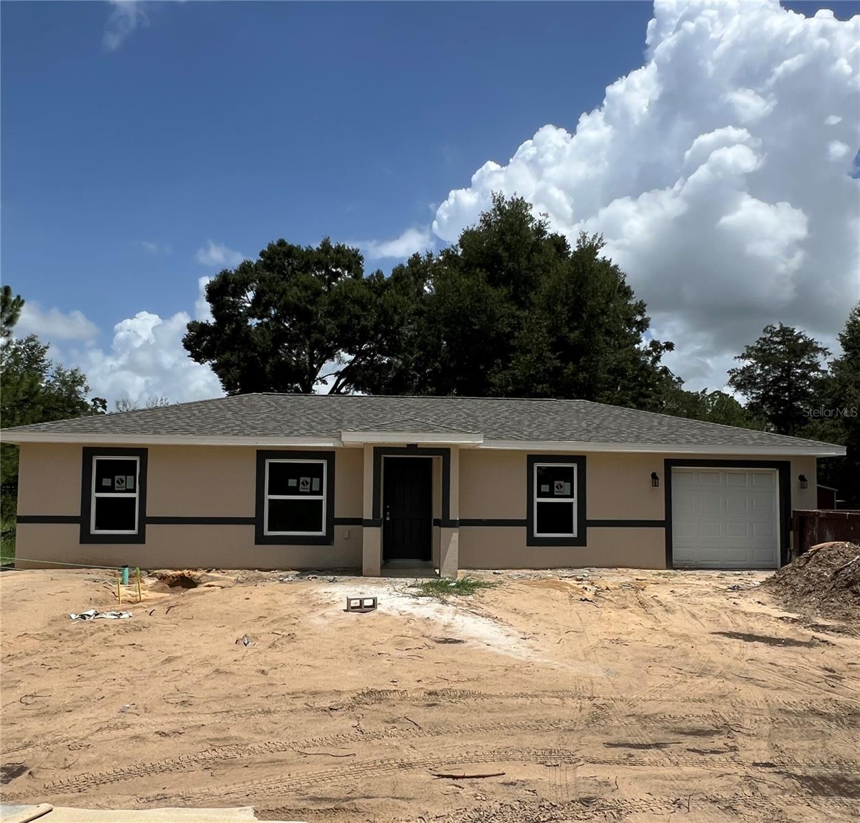 Under Construction. This stunning new home, currently under construction in the highly desirable Rainbow Lakes Estates, offers modern design and comfort in a welcoming community. The open concept living area seamlessly flows into the dining space, perfect for entertaining. The split bedroom plan provides privacy, with the master suite separated from the other bedrooms for a peaceful retreat. The contemporary kitchen features real wood cabinets, elegant granite countertops, and stainless-steel appliances, ideal for preparing meals and hosting guests. The home includes luxury LVP flooring throughout for easy maintenance and a sleek, modern look. Both bathrooms feature full tile for a sophisticated, durable finish. A large one-car garage provides ample space for extra storage. Step outside to the large, covered patio in the back—perfect for enjoying your morning coffee, relaxing, or hosting outdoor gatherings. Located in a vibrant community with paved streets, Rainbow Lakes Estates also offers a Lakes Community Center with a library, playground, and outdoor exercise area—everything you need for an active and fulfilling lifestyle.