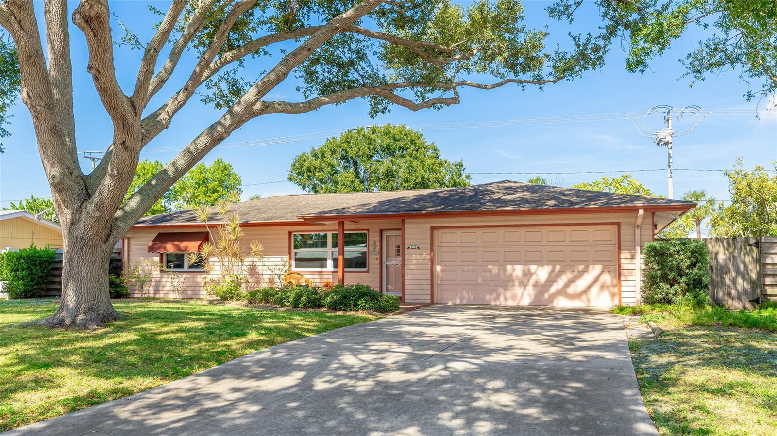 Discover this charming ranch style 2 bedroom 2 bath home with easy potential for a 3rd primary ensuite bedroom offering 1176 sf of living space just a short walk to grocery stores, shopping and restaurants.  Inside you'll find ceramic tile flooring throughout, knockdown ceilings, newer bathroom granite countertops and vanities and an remodeled kitchen featuring solid maple cabinets, granite countertops, stainless steel appliances and a large window overlooking the large private fenced backyard.  The spacious family room can easily be converted into a primary ensuite bedroom with room to add a closet or just enjoy it as a dining room or bonus room. Step outside to a 32 x 12 enclosed covered lanai with a tongue and groove wood plank ceiling, perfect for your morning coffee or evening relaxation while enjoying the views of your backyard and pergola. A large 12 x 10 indoor laundry room provides additional cabinet space with a built-in closet for extra storage that you're going to love. Recent updates include new 2016 windows and a garage door. The home's 20 year old roof has no maintenance issues however the new owner will need to take into consideration replacing this due to its age. With no HOA or rental restrictions this home also offers the potential for a primary residence, seasonal getaway or investment opportunity.