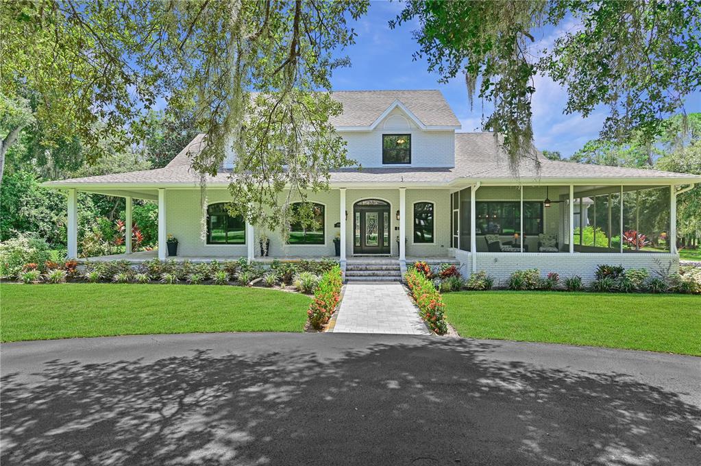 Below appraised value! You’ve found it, your dream home! Come check out this 3.5 acre compound, tucked away on Lake Nellie in Clermont. Located in the very secluded neighborhood of Lake Louisa Oaks, is a 6,850 sq. ft., executive estate, featuring a main house with a 2 car garage and a pool house with a 4 car garage. As you enter the circular driveway you’ll immediately be in awe of the main, two story, farm house style home, eloquently hugged by the wrap around front patio. Renovated in 2016, this beautiful marvel comes with 7 bedrooms and 5 1/2 baths! You’ll be sure to entertain in your newly remodeled gourmet chef’s kitchen, which opens up to the enormous 22x33” family room draped in astonishing bamboo flooring. On the first floor you’ll find two master suites, with the owner’s suite being OVER 1000 sq. ft. As you retreat to the massive owner’s suite you’ll find an entry sitting area, 10 ft. ceilings and a ridiculously huge walk-in closet with a custom organization system. The suite also offers lanai access, a spa-like bath with stone-top jetted tub, as well as a wraparound shower with multiple shower heads, and separate vanities.
The second floor to the main house has 3 large bedrooms and 2 full bathrooms. The designer courtyard, pool and spa are the centerpiece with gracious lanai areas that adjoin the entire rear of the home, complete with a summer kitchen and a new grill built in 2019.
From the main house walk under a breezeway to the remarkable 1 bedroom pool house. Fully equipped with a brand new kitchen, beautiful family room & a full pool bath with direct pool access. Plenty of open green space provides lots of room for all your toys and activities on the lush grounds.
The quiet neighborhood has access to the Clermont Chain of Lakes on Lake Louisa through the community boat ramp and dock. Price is set at appraised value.