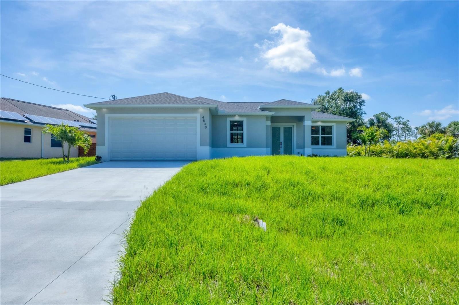 Under Construction. “Photos shown are from the model home”. This new construction home in North Port offers an open-concept floor plan with impact-rated windows and doors, quartz countertops in the kitchen and baths, and four 8-foot sliding glass doors that seamlessly connect indoor and outdoor living. The spacious patio is perfect for entertaining, while tile flooring throughout adds both style and durability. A dedicated home office with French glass doors provides a functional workspace. With elegant finishes, smart upgrades, and peace-of-mind features, this property presents an excellent opportunity to own a modern home in a growing Florida community. Schedule your private showing today — homes like this don’t last long!