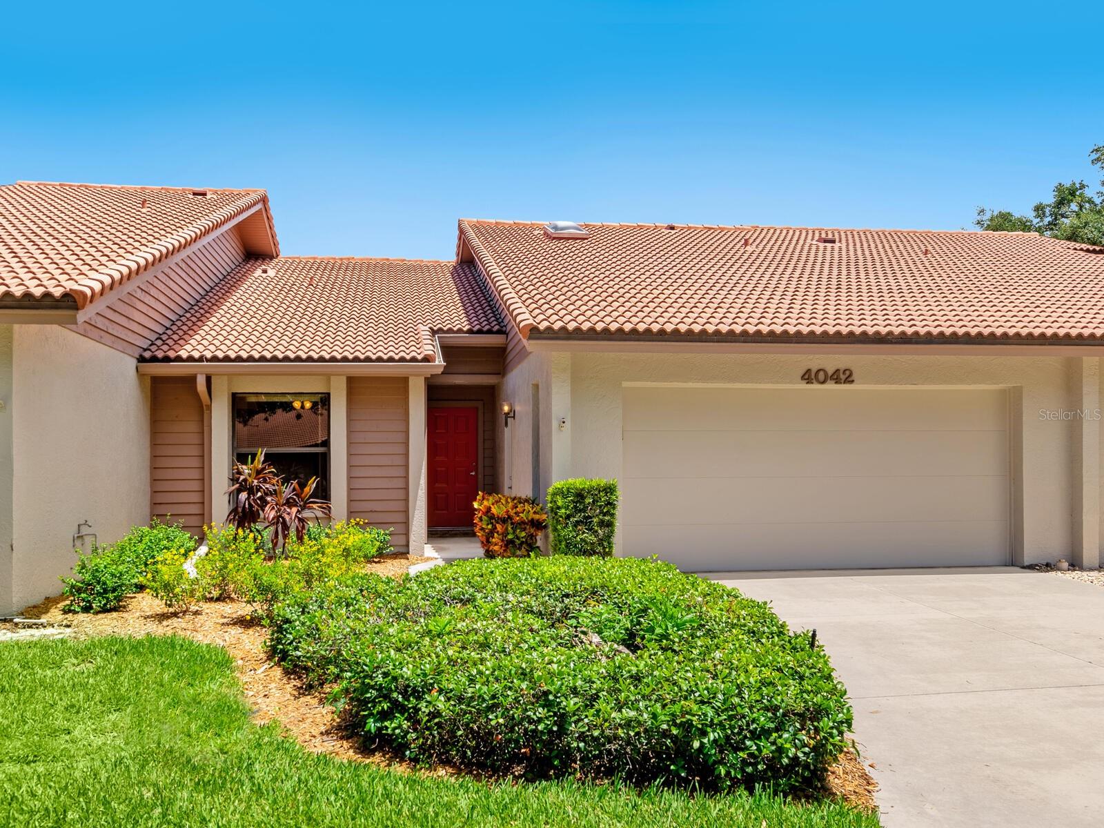 Bring your vision to life in this generously sized 2 bedroom plus a den villa in one of Sarasota’s most sought-after 55+ communities. Located on a quiet cul-de-sac off the main road, this home enjoys added privacy and no drive-by traffic. Featuring a well-designed floor plan, this villa offers vaulted ceilings in the living room with multiple skylights that bathe the interior in natural light. A long foyer is ideal for showcasing art or photography and leads into the living space. The galley-style kitchen includes a cozy breakfast nook with built-in cabinetry for extra storage and a large window that overlooks the lush, tropical backyard…your own private retreat. The spacious Primary suite features a large bathroom, walk-in closet, and a picture window looking outside framed by built-in closets on both sides for additional storage. The guest bedroom is situated on the opposite side of the villa providing privacy and comfort for visitors. The den, perfect for a home office or hobby room, is off the main living area and leads to a laundry room and attached garage, offering both functionality and convenience. The A/C unit was replaced in ’18, the interior re-plumbed in ’09 and the roof replaced in ’07. While the home is ready for your personal touch and updates, the potential is undeniable. With solid bones and a great layout, it’s a rare opportunity to create your dream home in a vibrant, amenity rich community that includes a heated saltwater pool, large clubhouse, 2 tennis and pickleball courts, along with a host of individual and group activities, all in a pet free environment. The maintenance fee covers the exterior of the villa and the lush grounds, allowing for truly easy living. Lakeshore Village is centrally located and offers easy access to shopping, dining, and the world renown Siesta Key Beach.