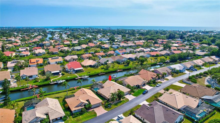 Welcome to The Inlets, a highly desirable waterfront community just one mile from Nokomis Beach. This beautifully maintained canal-front pool home features a NEW roof and pool cage (May 2025), resurfaced pool (Sept 2024), and a NEW electrical panel with built-in surge protection (Sept 2024). Enjoy boating from your private dock with lift or relax in the screened pool area with a spacious covered lanai. Inside, the extended Catalina open layout boasts a cathedral ceiling, tile floors, granite countertops, stainless-steel appliances, and a split floor plan for privacy. The primary suite offers wood floors, a walk-in closet, en-suite bath with walk-in shower dual sinks, and sliding glass doors to the covered lanai. Accordion shutters enclose the oversized lanai, and the extended 2-car garage adds convenience. Monthly fees include cable TV, internet, lawn care, exterior insurance, and access to resort-style amenities: heated pool/spa, fitness center, tennis, pickleball, clubhouse, and social activities. Pet-friendly (2 under 40 lbs). Enjoy peace of mind in Flood Zone X-500. Photos shown are prior to roof and pool cage replacement.