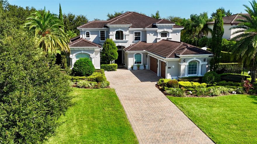 Buyer walked days before closing due to personal reasons! All inspections and milestones clean/clear!! - This exceptional Florida residence is perfectly sited on an acre within the exclusive guard-gated community of Bellaria. Thoughtfully designed to balance sophistication with comfort, the home welcomes you with an abundance of natural light streaming through broad front windows, highlighting the elegant handcrafted staircase in the foyer. The formal living and dining areas set the tone for refined entertaining, enhanced by a gas fireplace, a well-appointed wet bar, and expansive views of the sparkling pool and two-story covered porch. Just off the entry, the study provides an intimate retreat with porcelain flooring and clerestory windows, filling the space with natural light and framing serene outdoor vistas. The open-concept family room and kitchen create the heart of the home, where a wall of glass doors seamlessly blends indoor and outdoor living. The gourmet kitchen is a chef’s delight, featuring stainless steel appliances, exotic granite, custom cabinetry, tile flooring, and a spacious walk-in pantry. The first-floor master suite, thoughtfully tucked away for privacy, serves as a true sanctuary. Its spa-inspired bath is adorned with paneled cabinetry, exotic granite, a rainforest shower, soaking tub, and expansive closet areas—both beautiful and functional. Two additional en suite guest bedrooms, a versatile bonus room, and generous living and dining spaces make the main level ideal for everyday living or hosting. Upstairs, the thoughtful layout continues with three bedrooms, a loft, a sitting area, a bonus room, and even a second laundry room for added convenience. These flexible spaces adapt easily to the needs of a growing family or guests, offering opportunities for work, play, or relaxation. Blending elegance with livability, this home captures the essence of Florida living—where interiors open gracefully to resort-style outdoor spaces, making it perfect for both intimate family life and grand entertaining.