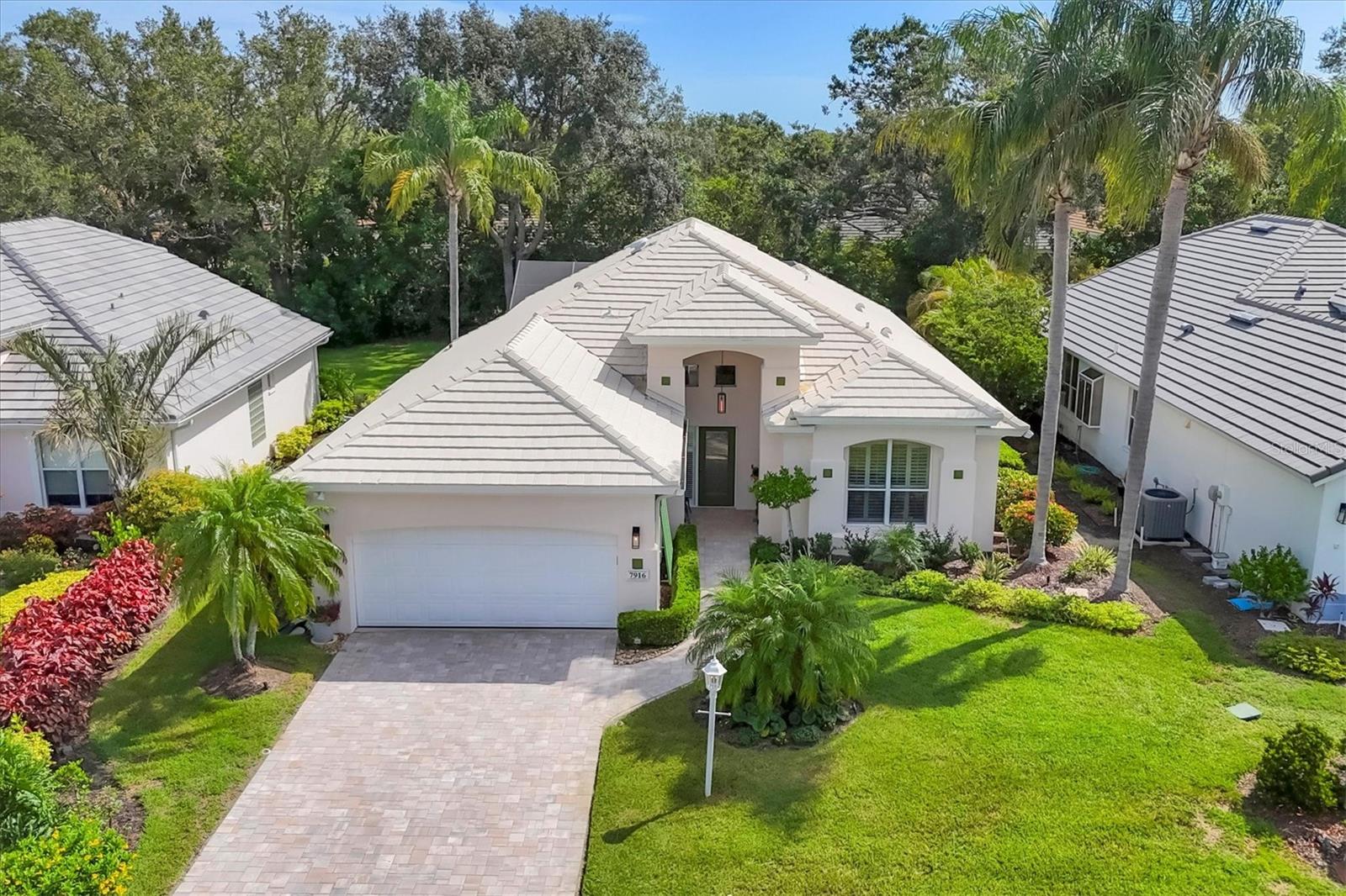 Welcome to this exquisite residence, perfectly nestled on a quiet cul-de-sac in the prestigious University Park. Designed for the buyer seeking a private, resort-style retreat, this home offers a seamless blend of sophistication, comfort, and maintenance-free living. This beautifully maintained home features an open-concept floor plan with a desirable split-bedroom layout that ensures privacy and spacious living. The grand open great room flows effortlessly onto the expansive screened lanai, creating an ideal space for both entertaining and peaceful outdoor relaxation. Step outside to your private caged, heated pool and spa, beautifully finished with Pebble Tec, offering a serene, resort-inspired experience. The outdoor retreat provides ample space for lounging, dining, and enjoying the Florida lifestyle. The chef’s kitchen is thoughtfully designed with granite countertops, under-cabinet LED lighting, and a bright breakfast nook surrounded by garden views. Recent updates include a new stove, refrigerator, and dishwasher, combining style and modern convenience. The owner’s suite is a true sanctuary, featuring oak flooring, a large custom walk-in closet, and a fully renovated bath with a new soaking tub, glass-enclosed shower, dual vanities, and tasteful designer finishes. The second bedroom, accented by French doors, is currently used as a light-filled office with two generous closets, offering versatility for a variety of needs. The additional guest suites are equally welcoming, with a renovated bath that features modern vanities and soft under-cabinet lighting. A dedicated utility room with a built-in sink and an adjacent oversized storage area provides excellent functionality and organization. Surrounded by lush, maintenance-free landscaping, this home offers a truly effortless lifestyle. A short walk leads to the exclusive Hampton Green community pool, where residents can relax or socialize in a tranquil setting. This exceptional property offers a rare opportunity to enjoy timeless elegance, complete privacy, and a relaxed, resort-inspired lifestyle. Location: University Park Country Club With its mature landscape and sprawling natural beauty, University Park is the premier master-planned community in the Sarasota area. Behind the secured, staffed entrance is an award-winning, resident-owned community featuring 27 holes of four-star rated golf, eleven lighted Har-Tru tennis courts, four pickleball courts, a fitness center, croquet, miles of tree-lined streets for walking or biking, and first-class dining. The community also offers numerous social activities and clubs designed to fit a variety of interests. Located just four miles from downtown Sarasota and its vibrant arts scene, museums, shopping, dining, and first-class healthcare, University Park provides an oasis from the city while keeping all its amenities within easy reach. A short 15-minute drive to the international airport and a 30-minute drive to some of America’s finest beaches, superb outdoor recreation areas—including the internationally renowned Nathan Benderson Park—the famed Ringling Museum, various boating options, and the acclaimed St. Armands Circle. Less than five minutes away from UTC luxury shopping and dining, University Park’s breathtaking beauty is unmatched by any other, offering a rare opportunity to own a home in one of Sarasota’s most coveted communities