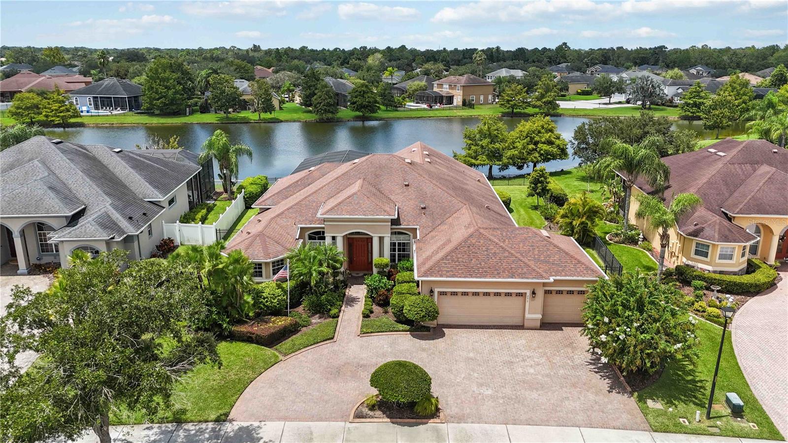 Discover this impressive 4-bedroom, 3-bathroom home in the sought-after Live Oak Reserve community, offering 3,071 square feet of living space. The backyard overlooks a peaceful pond and features a large screened lanai with a sparkling saltwater pool, creating a perfect setting for relaxation or entertaining. A beautiful circular driveway leads to the 3-car garage and sets the stage for the elegance inside. Step through the front door to high ceilings, crown molding, and a welcoming layout. The formal dining and family rooms greet you, followed by graceful archways that open into the modern kitchen. With stainless steel appliances, a breakfast bar, abundant cabinetry, and striking countertops, this kitchen is designed for both function and style. Just off the kitchen, the living room offers a comfortable gathering space. The primary suite features wood flooring and a spa-like bathroom with dual vanities, a soaking tub, and a walk-through shower. Additional highlights include a dedicated office and a versatile bonus room that can serve as a fifth bedroom. Live Oak Reserve offers resort-style amenities including basketball courts, a clubhouse, fitness center, recreational courts, and a community pool. With close proximity to Orlando, shopping, dining, and parks, this home offers an ideal balance of comfort and convenience. Mortgage savings may be available for buyers of this listing.