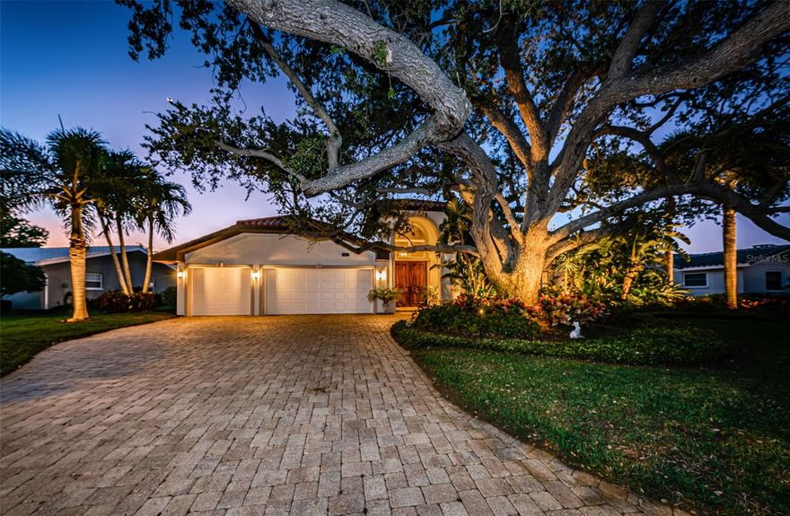 LOCATED IN ONE OF TAMPA BAY’S PREMIER BOATING COMMUNITIES, THIS LUXURIOUS 5 BEDROOM, 3 ½ BATH RESIDENCE IS EXQUISITELY AND METICULOUSLY UPDATED TO BRILLIANT EFFECT!  A lushly landscaped paver driveway transitions to a commanding 8ft mahogany double door covered entry, revealing a home of fabulous finishes and painstaking attention to detail. A grand 16ft-high foyer introduces beautiful flooring, artisan-quality woodwork & built-ins, radiant contemporary lighting, sumptuous wall finishes, tasteful window treatments, and custom Michael Bright display cabinet that deliver an alluring artistic appeal.  You’ll love how the windows and doors are flawlessly encased in wood.  The inspiring gourmet kitchen boasts wonderful granite surfaces, refined raised-panel coastal white cabinetry, a huge multi-level breakfast bar that seats six, an exceptional matching built-in credenza/buffet with substantial storage, and a superb custom dry bar with wine chiller.  Your generously-finished living room opens to the covered pool deck, as does the kitchen.  Resplendent French Oak wide-plank wood graces the bedroom floors with style!  Owner’s suite features 2 closets including a roomy walk-in closet system, and a magnificent, pampering bath with polished Travertine floors, extraordinary quartzite counter surfaces, dual vanities, a dedicated sit-down cosmetics center, jetted spa tub and striking glass shower enclosure richly-detailed in travertine.  2nd bedroom suite is large and has a posh, inviting bath with dual vanities and Patagonia Granite surfaces.  Spacious 3rd bedroom with waterviews opens to the pool deck.  Providing abundant storage and dual Patagonia Granite vanities, the oversized guest bath functions as a pool bath, with dedicated access to the pool.  Out back, discover an entertainment paradise - impressive 40ft-wide 550sqft covered pool deck has a beautiful built-in cooking center with new Twin Eagles grille, and SS refrigeration. Covered paver deck provides 3 distinct lounging/dining areas that overlook your dazzling pool & waterfront.  Sizable composite dock with 10,000 lb boat lift, offers plenty of seating area, power/water, dock lighting, sailboat-depth water w/no bridges and immediate boating access to the bay.  Extensive privacy landscaping, gas water heating, hurricane-protected windows/doors, and many, many extras.  An outstanding value in a great location near fine shopping, dining and excellent K-12 schools.  Measurements are estimates, buyer to verify.