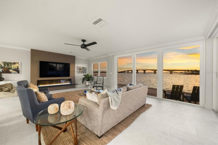One or more photo(s) has been virtually staged. Positioned on Sarasota’s sought-after Golden Gate Point, this exceptional Harbor House West residence combines waterfront luxury with the ultimate in city convenience. Just moments from the vibrant energy of downtown, enjoy effortless access to world-class dining, boutique shopping, cultural venues and waterfront promenade, all while returning home to a serene retreat with captivating views of Sarasota Bay, the Ringling Bridge and the barrier islands beyond. Reimagined in 2025, this residence showcases a fresh, refined aesthetic and thoughtful enhancements that make it the remarkable home it is today. Go through the glass front door into a light-filled open layout enhanced by tile flooring and crown molding in the main areas. The great room centers around a striking fireplace accent wall, while a wall of sliders frames an unforgettable panorama of the bay and bridge, where the water glistens by day and sunsets ignite the sky each evening. Just beyond, a concrete-enclosed patio offers a private setting for dining and lounging against the stunning waterfront backdrop. The beautiful new kitchen is a showpiece, featuring GE stainless steel appliances, including an induction cooktop, microwave drawer, and oven, plus a Fisher Paykel refrigerator, quartz countertops, tile backsplash and abundant wood cabinetry with upgraded hardware. A convenient laundry room with a stackable washer and dryer and extra storage enhances everyday functionality. Three spacious bedrooms ensure comfort and privacy. The primary suite boasts an expansive custom walk-in closet, oversized window with breathtaking bridge and bay views, and a spa-like bath with a long dual-sink vanity, linen cabinet and walk-in shower. Two guest suites each offer large closets and picture windows with water views. Additional highlights include assigned covered parking accessible from the unit with EV charger wiring run to carport ceiling for future installation, a day dock, ample guest parking, and pet-friendly living. Harbor House West provides a secure, well-managed community in a prime waterfront setting, delivering a balance of coastal serenity and downtown sophistication.
