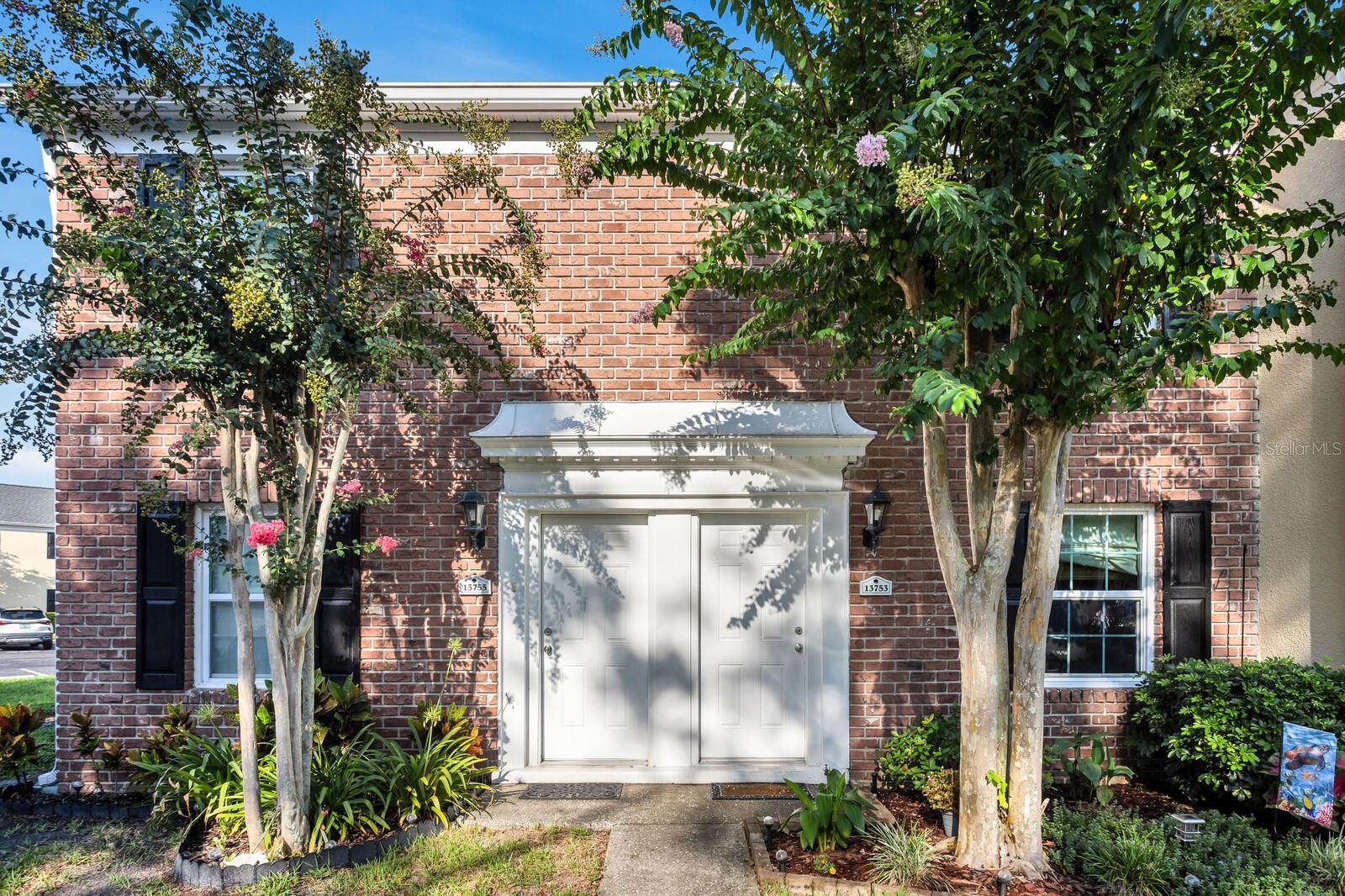 Welcome to this charming 2 Bedroom, 1.5 Bath, end-unit brick CONDO in the serene, gated Whispering Oaks community on Lake Magdalene. This well-maintained home offers peaceful LAKE VIEWS from both the family room and the primary bedroom. Inside, you’ll find an inviting eat-in kitchen with wood cabinetry, granite countertops, breakfast bar and stainless steel appliances (new in 2020). The family room features gleaming hardwood flooring, crown molding, and beautiful water views through sliders leading to the patio and water. Step outside to your private, fenced-in brick paver patio —perfect for relaxing or entertaining. A half bath and laundry closet with washer and dryer as well as under-stair storage complete the first level. Upstairs you'll find 2 generously-sized bedrooms with carpet. The primary bedroom overlooks the lake, and the second bedroom includes pull-down attic access for extra storage. The full upstairs bath has been stylishly renovated with tile flooring, a tub/shower combo, decorative vanity, and updated lighting. Additional upgrades include a new roof (2021) and new HVAC (2018). The Whispering Oaks community offers resort-style amenities including a pool, clubhouse, fitness center, boat ramp on this ski lake, car wash station, laundry facilities and a designated covered parking spot. Water and Sewer are included in the monthly HOA fee. Enjoy the quiet lakeside lifestyle just minutes from all the conveniences found in Tampa.