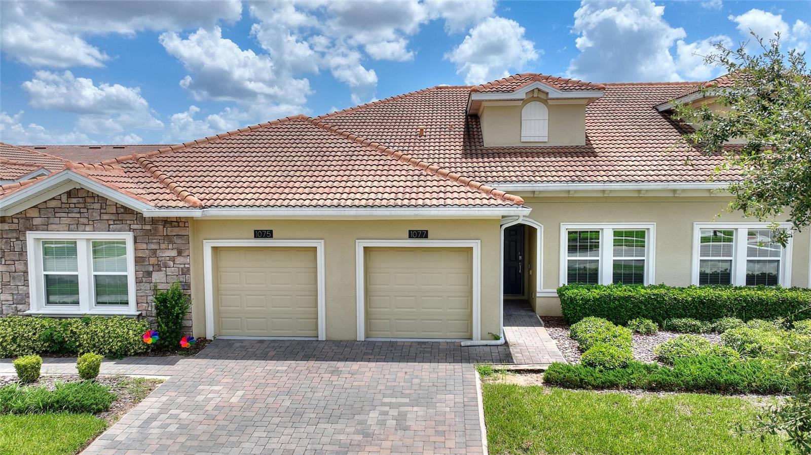 FULL GOLF AND TENNIS MEMBERSHIP INCLUDED IN HOA!!! Beautifully maintained and thoughtfully designed, this open-concept 2-bedroom, 2-bathroom villa is the perfect blend of luxury and comfort. IMMACULATE! LIGHT AND BRIGHT! Conveniently located just a short stroll from the neighborhood pool. The kitchen showcases elegant quartz countertops, slate-finish appliances, and a spacious breakfast bar, ideal for casual dining and entertaining. The primary suite offers a large, custom walk-in closet, dual sinks, and a walk-in shower. A generously sized secondary bedroom includes its own custom walk-in closet and access to a full bath. All closets throughout the villa have been professionally customized, maximizing storage and organization with high-end finishes. Additionally, a versatile flex room provides the option for a 3rd bedroom, office, or den to suit your lifestyle. Enjoy the ease of golf cart access throughout the entire community! This gated, resort-style community offers an unparalleled lifestyle centered around three exclusive clubhouses. The Oasis Club features a 14,000 sq ft clubhouse with a full-service restaurant, movie theater, fitness center, game room, tiki bar, lazy river, cabanas, and more. The private, resident-only Plaza clubhouse offers a second restaurant and bar, fitness center, game room, two pools, and pickleball courts—perfect for an active and social lifestyle. Now open, The Retreat Club features an exciting waterpark that brings even more fun for residents and guests. The HOA includes full access to all three clubhouses and their amenities, a complete golf and tennis membership, food and beverage credit, gated entry, full lawn maintenance, security monitoring, cable, phone, and internet. CDD and trash services are included in the property taxes. ChampionsGate Country Club offers the ultimate Florida lifestyle—whether you’re enjoying a round of golf, relaxing poolside, or dining with friends at one of the three clubhouses. All of this, just minutes from world-renowned theme parks, championship golf, premier shopping, and endless dining options in the Orlando area!