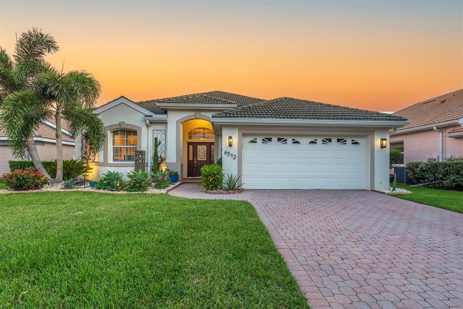 Tucked away in the sought-after neighborhood of Mote Ranch, adjacent to University Park Country Club, with extremely low HOA fees and fantastic amenities, this 3-bedroom, 2-bathroom gem offers the perfect blend of luxury, comfort, and convenience. With a 2-car garage, tile roof with 20 years of life left, and a long list of premium upgrades, this home is move-in ready and made for modern living. Step inside to soaring high ceilings, all-new ceiling fans, and a no-carpet interior that feels fresh and contemporary. The open-concept kitchen and family room combo is ideal for everyday living, while the massive living/dining room offers the perfect flex space for a home office or entertaining. This home's chef's kitchen features stone countertops, a built-in range and oven, and a sleek, modern design that flows effortlessly into the living space. The updated master bathroom and walk-in closet in the large primary suite add to the home’s luxurious feel. Your private backyard oasis awaits with a heated saltwater pool and spa, enclosed in a no-see-um proof pool cage for year-round enjoyment. Surrounded by stone landscaping, professional outdoor lighting, and no rear neighbors, this space is perfect for relaxing or entertaining in total privacy. This smart, secure & efficient home boasts a whole-home water purifier, filtration, and softener system, new AC (2023) for peace of mind, 3 Nest security cameras for added security, hurricane shutters for every window + soft shutter for the lanai, connection to a whole house generator system, seamless gutters, full irrigation system, and so much more. This home checks every box—luxury finishes, smart upgrades, and a location that can’t be beat. Enjoy access to a clubhouse, pool, and playground, all while being just minutes from top-rated schools, UTC shopping, dining, and more. Schedule your private tour today and experience the lifestyle you’ve been dreaming of!