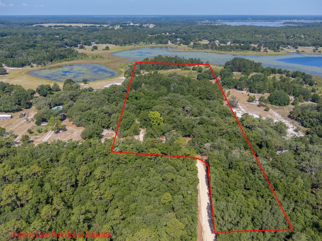 Immensely beautiful 14.13 acre property filled with mature trees, lake views, and endless possibilities! This property features an 1,152 sq ft mobile home that the owner has begun renovations on and just needs the finishing touches! Outside you will find an inground swimming pool with a newer pump, outbuilding providing shade while watching your family play in the pool, a large metal workshop, a large circular drive, and views of the lake from the back of your property! With a little TLC this home could be the perfect homestead!