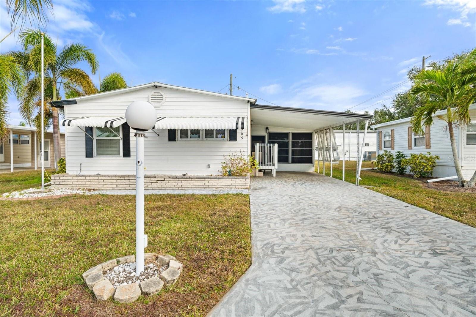This 2-bedroom, 2-bath home in the resident-owned Co-op community of Golf Lakes sounds like a great find! The low monthly fees and exclusive golf course make it an appealing option for those looking for a Florida lifestyle with superior amenities. The open floor plan, updated windows, and newer roof add a modern touch, while the laminate flooring enhance the overall feel. The spacious bedrooms offer dual closets and built in dresser space, both bathrooms have updated walk in showers. Screened-in lanai, open deck in backyard and large carport add plenty of extra room for comfort and relaxation. Plenty of extra storage space with additional shed and washer dryer hook ups. Being close to the clubhouse, shopping, dining, srq airport, UTC Mall and the beaches of Anna Maria Island (only 10-15 miles away) is a huge plus too. A fantastic place for enjoying both the indoors and the outdoors.