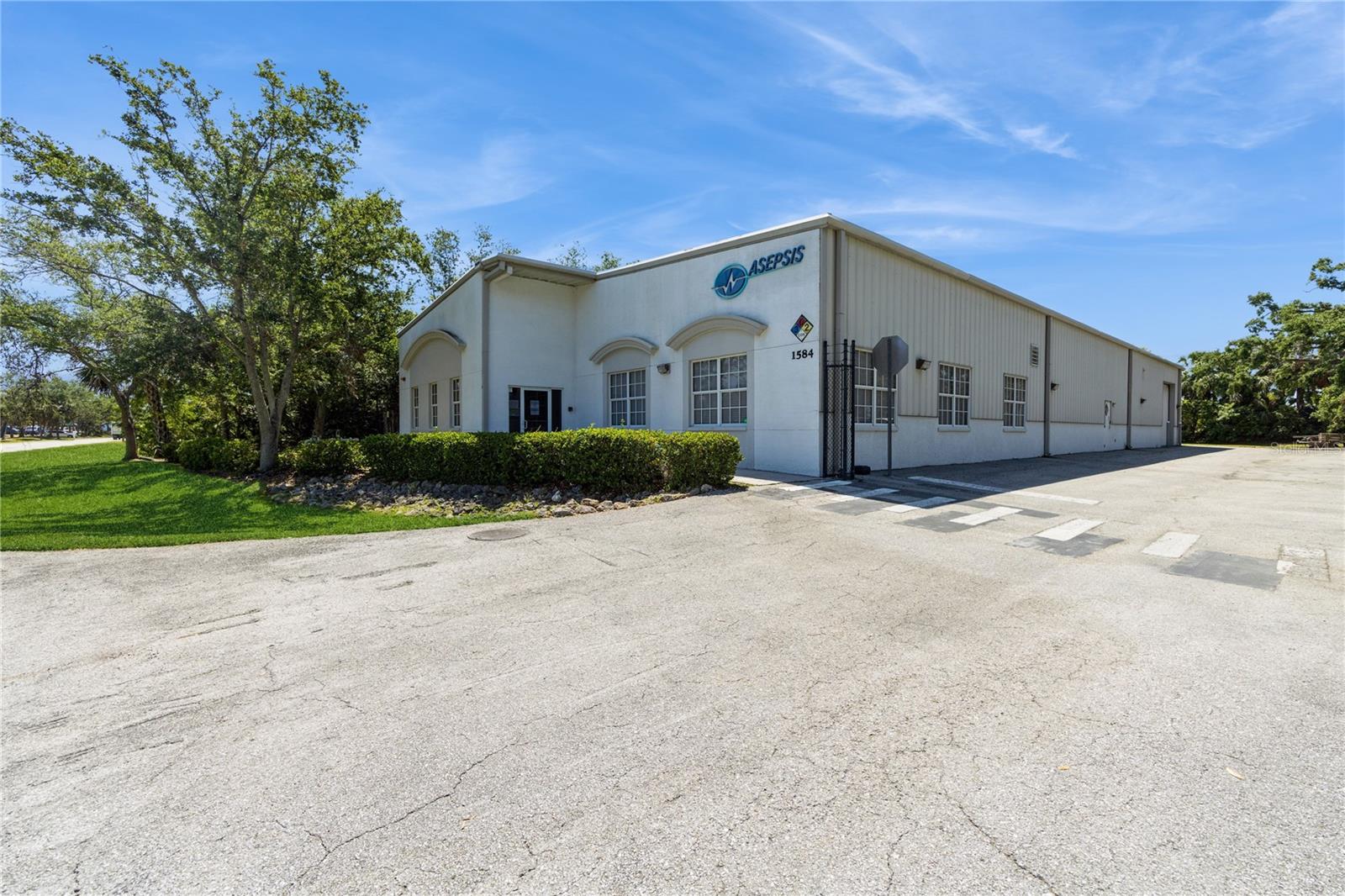 1584 Independence Boulevard is 9,130 SF light manufacturing and industrial warehouse in Sarasota that seamlessly blends functional design with specialized infrastructure. Previously home to a pharmaceutical excipient manufacturing facility, the building is outfitted with four electrical panels (powering up to 1,650 amps) and has two ISO Class 7 clean rooms, four HVA systems for independent environmental control, and computerized monitoring for interior humidity and temperature—making it an exceptional choice for regulated manufacturing environments, close to Downtown Sarasota.
The warehouse component features ceilings ranging from 16 to 22 feet, as well as three drive-in doors for efficient loading. The property also benefits from an administrative component that includes a fully built-out office suite and conference room. As one of Sarasota’s first Dean Steel buildings, the property features robust structural and security integrity. Located with immediate access to major North-South transportation corridors, this property offers an unmatched blend of location, layout, and high-performance features—perfect for businesses looking to optimize logistics or maintain specialized production standards.
Key Highlights:
• 9,100 SF of warehouse and office space
• 3 drive-in loading doors
• 16–22 ft clear height ceilings
• 2 ISO Class 7 clean rooms
• Zoned HVAC systems and climate monitoring
• Fully built-out office and conference areas
• Convenient access to major distribution routes
• 4 Fully built-out offices and conference areas
• Barbed-wire security fencing