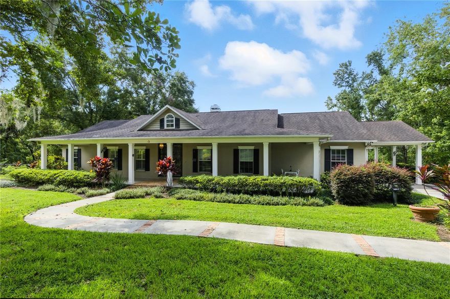 Welcome home to a countryside paradise with this two parcel estate nestled on 32.17 acres of rolling countryside. Enter through the rod iron gate and down the long private driveway to this custom-built 3-bedroom, 4-bath pool home offering 2,829 sq ft of refined living space, surrounded by serene pastures, 2 natural springs, hardwood hammocks and a creek that flows down through the property. Long private drive leading to a peaceful, park-like setting with elevations over 165'. Brick accent floors crafted from repurposed prohibition era Chicago bricks, and expansive windows with hillside and pool views. Gourmet kitchen with quartz countertops overlooking the living area, premium kitchen appliances, and custom oversized cabinetry. Plantation shutters on double-pane insulated windows for comfort and efficiency. Outside you will find a 26'x61' screened lanai with heated spa, elevated Chicago brick patio, and pool cabana with outside bathroom and dining area, sprawling front porch perfect for morning coffee or evening sunsets, Two flowing creeks, a natural spring, and cross-fenced pastures currently supporting cattle. In addition, Detached 39'x39' studio or In law suite with full bath, vaulted ceilings, and pecky Cypress wood accents—ideal for an art or music studio, guest suite, or home office. 36'x48' concrete block barn for equipment and hay storage. All of this, just 7 minutes from I-75 for easy access to Tampa and only 3 minutes from charming downtown Dade City. This estate is a rare blend of rustic charm and modern luxury, offering privacy, character, and endless possibilities.