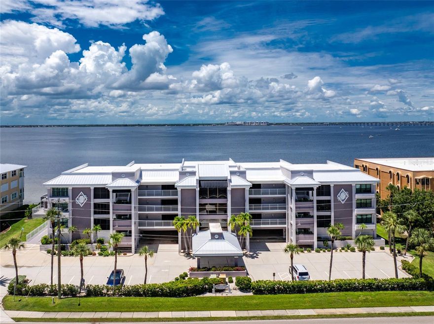 CHAMPAGNE WISHES DO COME TRUE! THIS LOVELY HARBOR FRONT 3RD FLOOR CORNER CONDO AT CHAMPAGNE ESTATES IS WAITING FOR YOU! Being sold furnished as seen, just bring your bathing suit and toothbrush and start living the "Salt Life". 2,280 square feet with 38 feet of floor to ceiling impact glass overlooking beautiful Charlotte Harbor and the open areas have endless possibilities. This unit has had extensive updating over the past several years. Large neutral tiled flooring on the diagonal through all the living areas and one bedroom/office. Quality carpet in the other two bedrooms. The living room has a decorative non-working fireplace that could easily be converted into an electric fireplace. Large open kitchen features wood cabinets, granite counters and stainless steel appliances.  Wake up looking at the tranquil harbor from this spacious primary suite with a large walk-in closet, his and hers separate bathroom vanities and a lovely glass block walk-in shower. 7x10 Laundry room has a built in ironing board. On the 1st level covered parking space # 7 and the     6.5 x 14.5 ft storage unit #221 with lots of shelves is located on the west side. Enjoy the heated pool, spa and recently remodeled club house all with harbor views too! Walking distance to Fishermen's Village, Isles Yacht Club, downtown Historic Punta Gorda and it's 18 miles of biking and walking trails. 2 pets up to 30 lbs. each are allowed. This is truly Paradise so do not hesitate, make an appointment to preview this stunning unit as it won't last long!