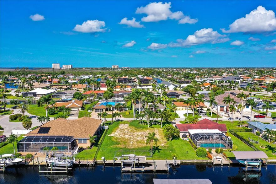 This is a unique find! Vacant land with fantastic direct Gulf access with no bridges & sailboat access! This property is ready for you to build & already has a private boat dock. The dock includes a 13,500 lbs boat lift, a wrap around deck for easy access around your boat, as well as 2 jet ski lifts! The original home has been torn down and the parcel is cleared, just waiting for someone to start constructing their dream home in SWFL. Situated in a highly desired SE corridor of Cape Coral. Perfect for you to enjoy the waterways of the Gulf of Mexico & Calossahatchee River. Close to downtown Cape Coral for dining, shopping, & entertainment.