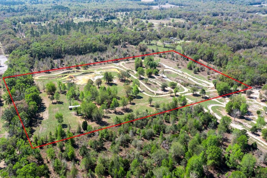 For the right buyer, this property changes how you spend your time. Fort White. Columbia County, Florida. This 10.79-acre property features nearly one mile of established motocross track, thoughtfully laid out to maximize ride time and flow across the property. The track includes spaced jumps, berms, straights, and a “fun box,” creating sections designed for progression, timing, and controlled riding… not a basic recreational loop. The track has been used by a family of competitive riders and offers an intermediate to advanced riding environment. It supports both consistent training and everyday riding. If your weekends are spent loading equipment, driving, and waiting for ride time… this property gives that time back. Ride in the morning, take a break, and ride again… all on your own schedule. While designed for motocross, the layout may also appeal to 4-wheelers or similar off-road vehicles. THIS IS A PRIVATE RIDING ENVIRONMENT INTENDED FOR PERSONAL USE...NOT A COMMERCIAL OR PUBLIC TRACK. A newer 12'x30' storage building provides space for equipment and gear with active electrical service, there is also a well onsite. Separate from this, there is ample space to set up a homesite or weekend base, allowing you to stay on the property and make the most of your time. Bring an RV, create a simple setup, or build over time… ride, rest, and stay. Location matters and this property offers access to the Suwannee River, Ichetucknee Springs State Park, and Rum Island Park… known for boating, fishing, swimming, and tubing. Approximately 15 minutes to High Springs, known for its proximity to world-renowned cave diving, natural springs, and local dining. About 45 minutes to Gainesville for medical services, shopping, restaurants, and employment, including UF and UF Health and Malcom Randall VA Hospital. CONVENIENT ACCESS TO I-75 allows for straightforward travel north or south to surrounding areas. This property is not designed to appeal to everyone… and that’s exactly what makes it unique for the right buyer.