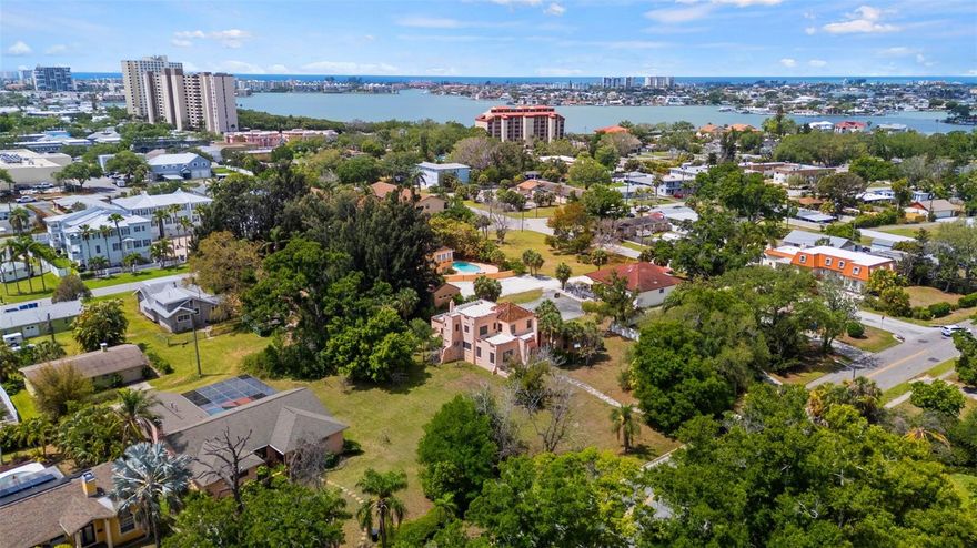 Excellent Opportunity in Pasadena: Three Lots with Alley Access.  Surveys are available, along with a letter from the City of St. Petersburg confirming three buildable lots. The Park Street location offers convenient access to shopping, dining, local beaches, Gulfport and Downtown St. Petersburg.  This distinguished Mediterranean-style residence, constructed in 1925, retains numerous original features, including hardwood floors, beamed ceilings, stucco walls, and vintage glass doorknobs—a testament to its historic character. The property encompasses three lots, with the main house spanning two western lots and the third lot remaining undeveloped. Options include retaining the third lot for amenities such as a pool, cabana, or guest house, or selling it to finance restoration efforts. The home requires significant renovation, including a new roof, plaster repairs, plumbing and electrical upgrades, and kitchen and bathroom modernization. Prospective buyers should be prepared for extensive restoration.  The seller prefers to sell all three parcels together.  Survey and Elevation Certificate Available.