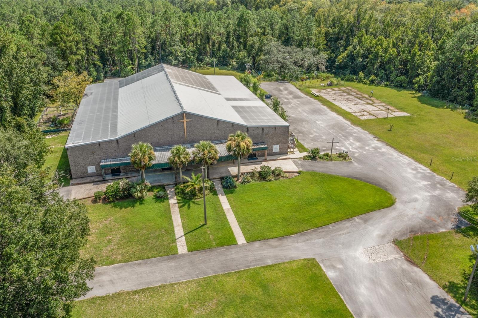 Rare opportunity for a 2 story 28,000+ Sqft steel frame commercial building on over 18+ Acres with a pond on busy highway. Currently the property is used as a Church with main worship area, nurseries, classrooms, offices, play area, 4 sets of men's & women's restrooms, a commercial kitchen, a spacious welcoming area and so much more. The property is hooked to public water and has it's own septic, multiple parking areas, 2 playgrounds, a 1200 sqft storage warehouse and also includes wooded acreage with a pond that has approximately 13 Acres of potential Wetlands. The property is in a prime location directly on Moody Blvd and minutes from I-95, US Highway 1, Advent Health Hospital, & Flagler Executive Airport. The roof is original, and currently there are some active leaks, thus it is being sold as-is. The building has great bones and could be used for a myriad of different uses. Seller will consider owner financing for the right buyer with a good down payment. Some permitted uses may include: Retail, Restaurants, Cocktail lounges, Hotels, Group homes, Nursing homes, Day care centers, Hardware or building supply stores, Vehicle sales, Private clubhouses, Bowling alleys, Game rooms, Funeral homes, Churches, Adult arcade or amusement centers.