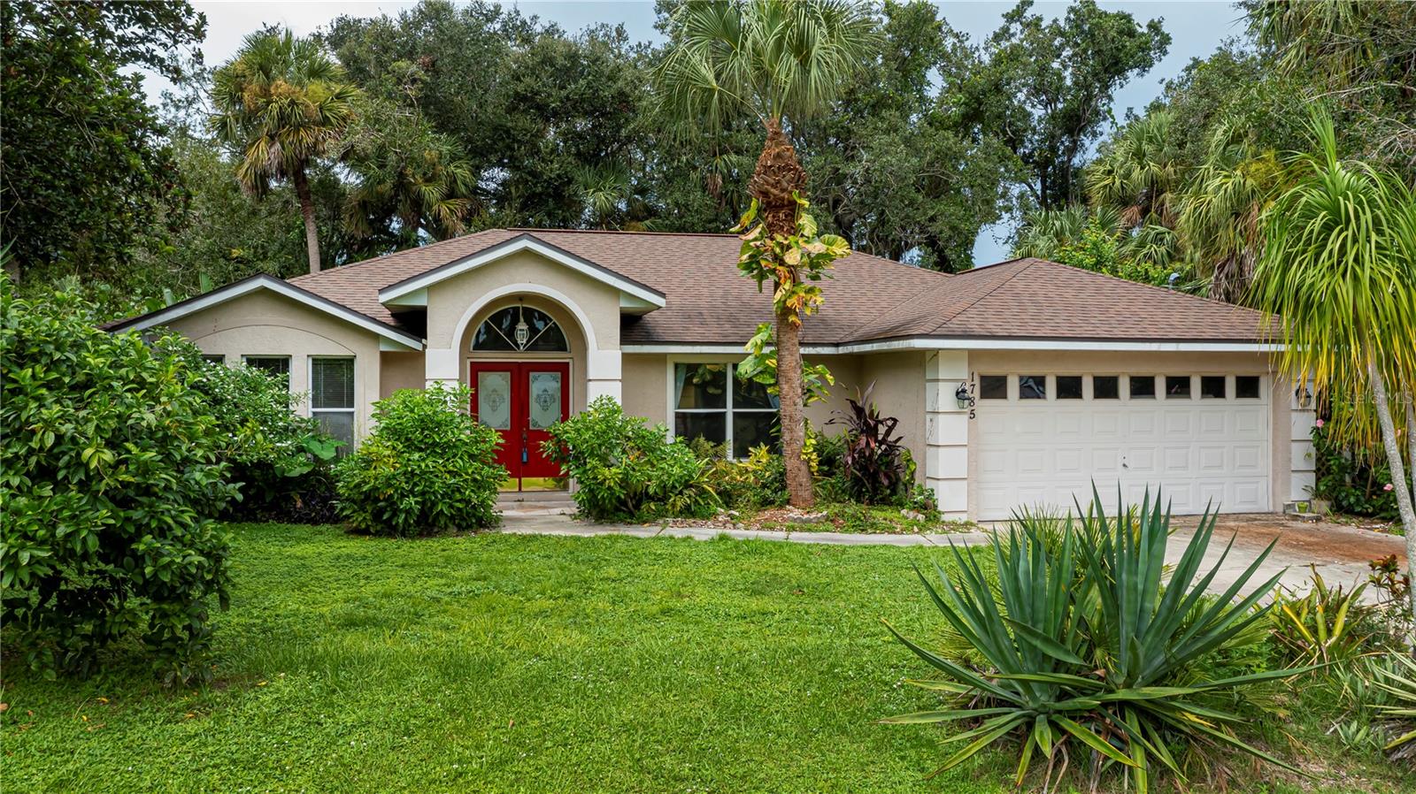 READY TO ADD YOUR FINISHING TOUCHES...attention investors, here's the one you have been searching for! Charming 3-bedroom, 2-bath, 2-car garage home in North Port featuring a soaring entryway and a long driveway. Inside, discover beautiful angular details including an arched foyer, decorative plant shelves, high ceilings, and plenty of natural light throughout. The kitchen offers a full pantry, breakfast bar, granite countertops, and a convenient pass-through to the screened patio.
The spacious living and dining rooms are perfect for entertaining, with sliding doors opening to the lanai. This thoughtfully designed split floor plan highlights a large master suite complete with an en-suite bathroom, generous walk-in closet, and a pocket sliding door leading to the screened lanai.
Both guest bedrooms include fans and closets, sharing a centrally located bathroom with the rest of the home. Full two car garage has a garage door with windows lined across the top for any hobby enthusiast to easily work comfortably here. Washer and dryer are also located in the garage laundry area. Enjoy the cross breezes night or day overlooking the serene backyard on your screened lanai. Room for a pool with the deep back yard is also an option. Step outside to fully enjoy the tropical feel backyard retreat surrounded by mature trees, fruit trees, and a charming rustic swing.
No HOA or flood insurance is required.located near to many amenities. North Port has Myakka State Park and Myakkahatchee Creek Environmental Center Park with miles of great trails, horseback riding, hiking, bird watching, biking, water views and access. Close to PG airport, dining, shopping, Stadium and beaches, Warm Mineral Springs and Aquatic Center.This home is priced to allow you to add your personal touches and is being sold as-is. Act quickly—this opportunity won’t last!