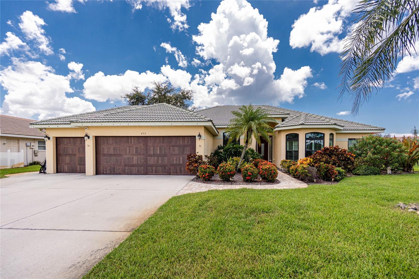 Located in the Exclusive Waterfront Community of Englewood Isles, this amazing 4 bedroom, 2.5 bathroom and 3 car garage home has it All! As you enter through the etched glass front door, you will fall in love with the soaring ceiling and NEW Tile Floors! Gaze through the PGT Wind Guard Sliders (2020) from both the Master Bedroom and Family Room that lead out to the lanai. Imagine entertaining your guests in your oversized dining room adjoining your beautiful NEW Kitchen, adorned with quartz countertops, shaker style white cabinets, built-in oven and NEW Stainless Steel Appliances. Custom bench seat built in under the aquarium glass window. Spend time relaxing on your expansive lanai, decompress in your heated spa or float around in the pool, enjoying the warm sunshine, surrounded by your park-like backyard. The covered lanai features a Weber Slate propane grill with a vented exhaust fan and a pool bath. Enjoy the ambience of the propane fueled, authentic tiki torches or cozy up to the fireplace in the family room on those cool winter nights. Find solace and comfort in your spacious primary bedroom with high ceilings, walk-in closet with custom organizers and renovated ensuite bathroom! This split floor plan features two secondary bedrooms that share a full bathroom between. A third guest bedroom with a closet doubles as an at home office. All windows (except aquarium glass in kitchen) were replaced in 2020 with PGT Wind Guard. The 3 car garage may be every man's dream! The insulated, hurricane impacted door, mini split AC and epoxy floor complete the space. Other valuable additions to the house include HVAC replaced 2022, brand new pool heater, a water purification system, central vac system, well pump replaced 2019, underground propane tank, interior painted in 2025 and paver walkway extending from the driveway on the east side to the lanai. Within the community there is a marina situated on Forked Creek, leading out to Lemon Bay and the Gulf of America. Lease or purchase a boat slip right in your community! Take a short car ride to any four public beaches located on Manasota Key to enjoy the aqua blue waters. This is the perfect location! Centrally located near all of the action of Venice and Englewood. Many public golf courses to choose from, quaint restaurants with exquisite cuisine and Weekly Farmers Markets, providing locally grown fresh produce and goods. Come live the Florida Dream!