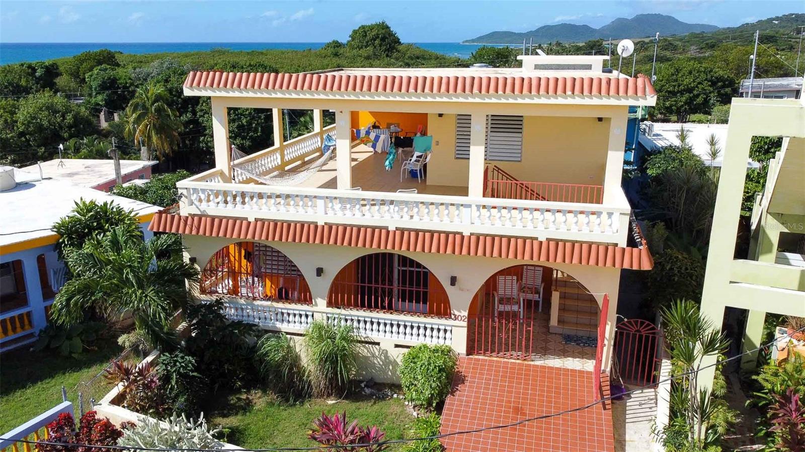 Welcome to "Casa Amarilla," a captivating multi-unit property located at 302 Calle Almendro in the lively barrio of Esperanza on the enchanting island of Vieques, Puerto Rico. We're thrilled to introduce you to a solid-construction residence that promises not just a home but a gateway to the Caribbean lifestyle you've dreamed of. "Find Your Paraiso in Puerto Rico," as we say, and it starts right here with Casa Amarilla.
Picture yourself in a two-story haven painted in vibrant tropical hues, reflecting the lively spirit of its surroundings. The standout feature of this property is undoubtedly the expansive covered patio on the upper floor. From here, you are treated to breathtaking views of the shimmering Caribbean Sea to the south and the majestic mountain of Mount Pirata to the west. Imagine enjoying your mornings and evenings here, the skyline a canvas of color and beauty, a perfect backdrop for your new life in the Caribbean.
The upper level of Casa Amarilla features a studio unit that boasts a kitchen, a full bath with high ceilings and glass block for ample natural light, and generous living space including closet storage and a comfortable bed area. Step outside to the patio deck, outfitted with dining tables, lounges, and hammocks—ideal for relaxing, entertaining, or simply soaking in the vistas.
Descending the covered concrete staircase brings you to the first floor unit, which includes three bedrooms and two bathrooms. The combined kitchen, living, and dining area opens onto an east-facing porch, catching the cool trade winds—a delightful spot for your morning coffee. The primary bedroom benefits from an ensuite bathroom, ensuring privacy and convenience.
Both kitchens in Casa Amarilla feature sit-down counter space, perfect for casual meals or chatting with guests while cooking. Each bedroom on the lower floor is equipped with air conditioning, providing comfort in the warm Caribbean climate. Additional practical features include a large roof ideal for installing solar panels, concrete flooring on the basement level for enhanced durability, and a dedicated laundry room.
Located on a quiet cul-de-sac street, Casa Amarilla offers privacy and a sense of retreat while being just moments away from the Esperanza Malecon. This area, once a humble fishing village, has blossomed into a vibrant hub of tourism. Here, you'll find boat moorings, charming gift shops, inviting restaurants, and the gateway to the mesmerizing BioBay—renowned for its bioluminescent waters that offer an unforgettable nighttime spectacle.
Life on Vieques is an unending adventure with its pristine beaches, diverse restaurants, and rich wildlife. Each day promises a new discovery, from tranquil mornings on sunlit shores to exploring local cuisines that capture the essence of the Caribbean. Casa Amarilla places you at the heart of this vibrant culture.
Whether you're seeking a permanent residence, a vacation home, or a smart investment opportunity with its rental potential, Casa Amarilla represents the pinnacle of Vieques real estate.
Embrace the opportunity to live where others vacation. With its compelling combination of privacy, comfort, and proximity to local attractions, Casa Amarilla isn't just a property for sale; it's a ticket to a lifetime of Caribbean sunsets and leisure.