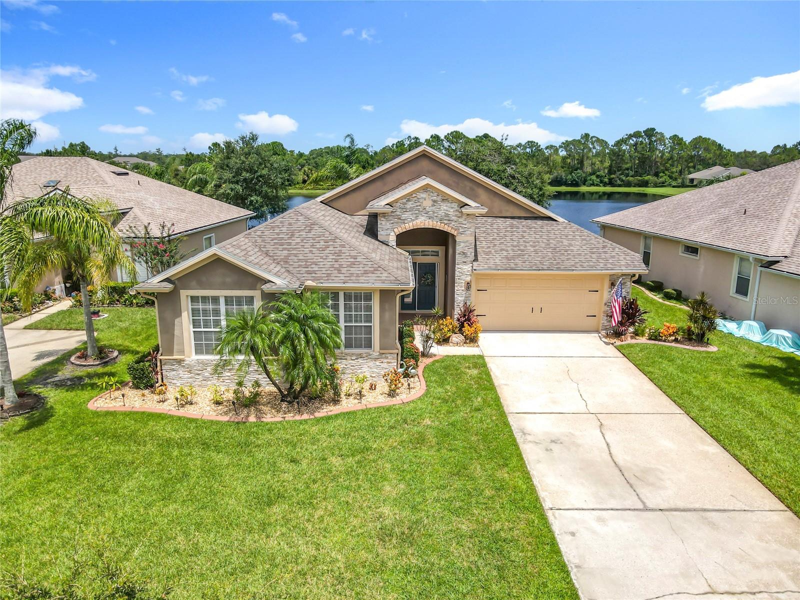 3 bedroom 2 bath lake front home with optional 4th flex bedroom/office located in the desirable LPGA Golf Community in Daytona Beach Fl has a open spacious floor plan with living room area directly overlooking the lake and spacious back yard. Modern kitchen with granite countertops and breakfast bar and dining nook. Nicely sized bedrooms with ample closet space. Luxury vinyl flooring throughout the home. The primary bedroom affords a sliding glass door leading to the covered screened in porch area. His and her closes and large walk in shower is something to beholds. Other features of the home include, newer roof in 2018, landscape curbing, stone/brick facia on the front of the home, hurricane shutters, curbscaping with landscape rock for easy maintenance. Backyard firepit, new ultra quiet garage door opener and new hotwater heater. The home is situated in the LPGA golf community which features 2 18 hole golf courses, club house, pool and restaurant. Close to shopping, minuets to the beach and less than 1hr to Orlando attractions. Discover this charming 3-bedroom, 2-bathroom lakefront home, with an optional 4th flex bedroom/office, nestled within the sought-after LPGA Golf Community in Daytona Beach, FL. This open and spacious floor plan boasts a living area with direct lake views and a generous backyard. The modern kitchen features granite countertops, a breakfast bar, and a dining nook. Bedrooms are nicely sized with ample closet space, and luxury vinyl flooring extends throughout the home. The primary bedroom offers a sliding glass door leading to a covered, screened-in porch, along with "his and her" closets and a large walk-in shower. Additional features include a newer roof (2018), attractive landscape curbing, a stone/brick façade, hurricane shutters, and low-maintenance curbscaping with landscape rock. Enjoy the backyard firepit, a new ultra-quiet garage door opener, and a new hot water heater. Residing in the LPGA golf community affords membership optional access to two 18-hole golf courses, a clubhouse, pool, and restaurant. The home is conveniently located close to shopping, minutes from the beach, and less than an hour from Orlando attractions.