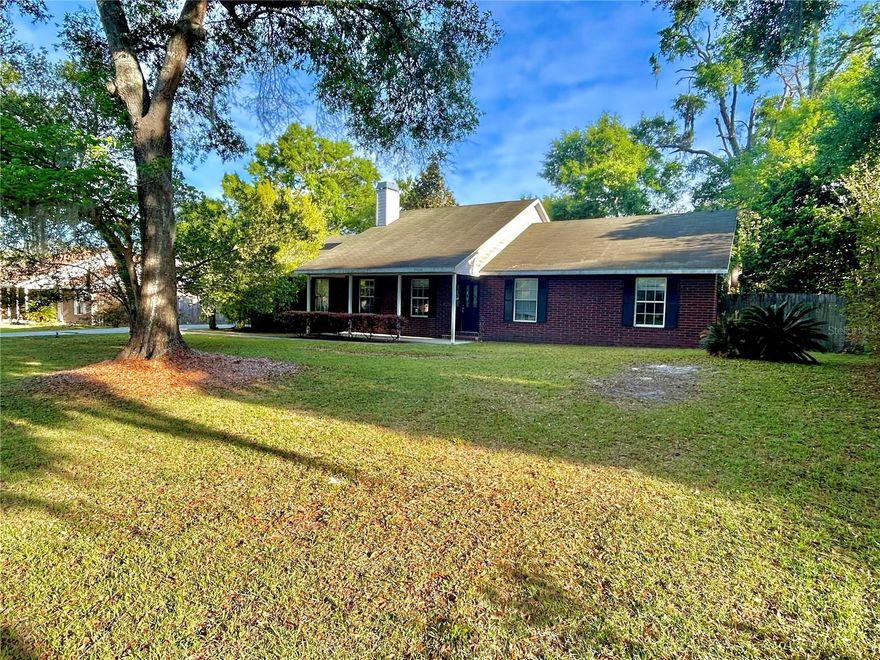 One or more photo(s) has been virtually staged. Welcome to this solid 3-bedroom, 2-bathroom brick home nestled in the charming Cottages of Country Way neighborhood in Newberry, Florida. Situated on a generous 0.30-acre lot, this property offers plenty of room to enjoy both indoor and outdoor living. Inside, you’ll find a spacious great room layout with a wood-burning fireplace enhanced by tall, vaulted ceilings that create an open, airy feel throughout the main living area. The kitchen and living spaces flow together perfectly for entertaining or relaxing evenings at home. While the home will benefit from new flooring and fresh paint, it offers a solid foundation with endless potential to make it your own. Step outside to relax on the covered front porch or enjoy morning coffee on the covered back porch, overlooking your private yard. The property also features a large 440 sq. ft. garage with tall ceilings—ideal for abundant storage or hobby space. Inside, the laundry room provides ample storage and everyday functionality. With its inviting layout, sturdy brick construction, and fantastic location close to Newberry’s schools, parks, and shops, this home offers outstanding value and the opportunity to personalize it to your taste. A perfect blend of potential and charm—ready for your finishing touches to make it shine.