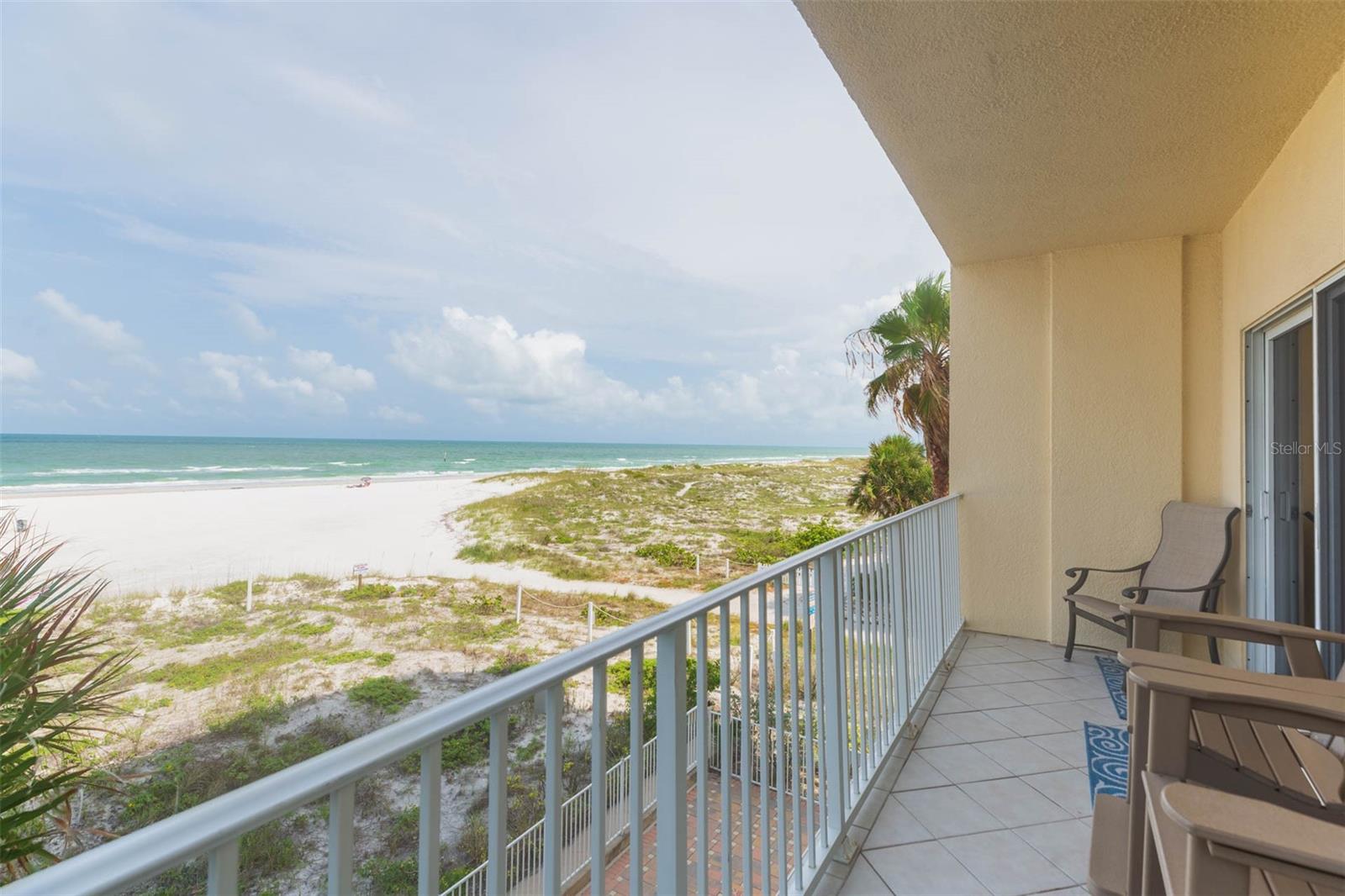 Paradise found in this elegant condo offering panoramic views of the Gulf of Mexico, miles of sugar white sand beaches and spectacular sunsets. Chateau on White Sands is an exclusive, 13 unit community on one of the most desirable beach locations. Mornings will be spent walking on one of the best rated beaches in the world and evenings will provide some of the most breath-taking sunsets in the world. French doors invite you into this spacious home with 10-foot ceilings, miles of crown molding, illuminated tray ceilings, and stunning marble flooring. You will enjoy the chef’s kitchen with maple glazed cabinetry, Sub Zero refrigerator and wine cooler, built in Miele coffee/cappuccino/expresso machine, six burner gas cooktop and vent hood, Wolfe convection oven and Bosch dishwasher. Long granite countertops accommodate four bar stools, perfect for catching up after a memorable day. Formal dining allows for cozy dining or an extended table for holiday gatherings and entertaining family and friends. An adjacent private balcony is perfect for catching up on reading or relaxing to the sound of the waves. The spacious living area has double sliders and multiple windows to view the gulf and the large, covered wrap around deck beckons you (and your guests!) to sip wine while watching the sun go down. The primary suite is the ultimate sanctuary. French doors invite you into the oversized bedroom which has a tropical flair. Palm trees outside the windows sway in the breeze and another private balcony for morning coffee. Two large closets and an ensuite master bath with jetted tub, separate shower, granite counter tops and double sinks. Two guest suites, each with their own ensuite bath are located on the other side of the home. A fourth bedroom/den/office as well as a powder room separate the spare bedrooms from the primary for additional privacy. An oversized laundry room, complete with Bosch washer and dryer, sink and additional storage area is also between the primary and guest suites. NEW A/C in 2020, NEW hot water tank in 2020, NEW ceramic tile and bedroom carpets in 2022 and custom painting in 2018. Chateau on White Sands offers many amenities including a private heated pool with a view of the gulf, workout facilities, community room and additional storage areas. Two assigned parking spaces are under cover and secure and the state-of-the-art card entry system takes you directly to your personal lobby. Living at Chateau on White Sands in Clearwater Beach provides the ultimate in privacy while enjoying high end restaurants, world renowned beaches and resort style living. Love where you live!