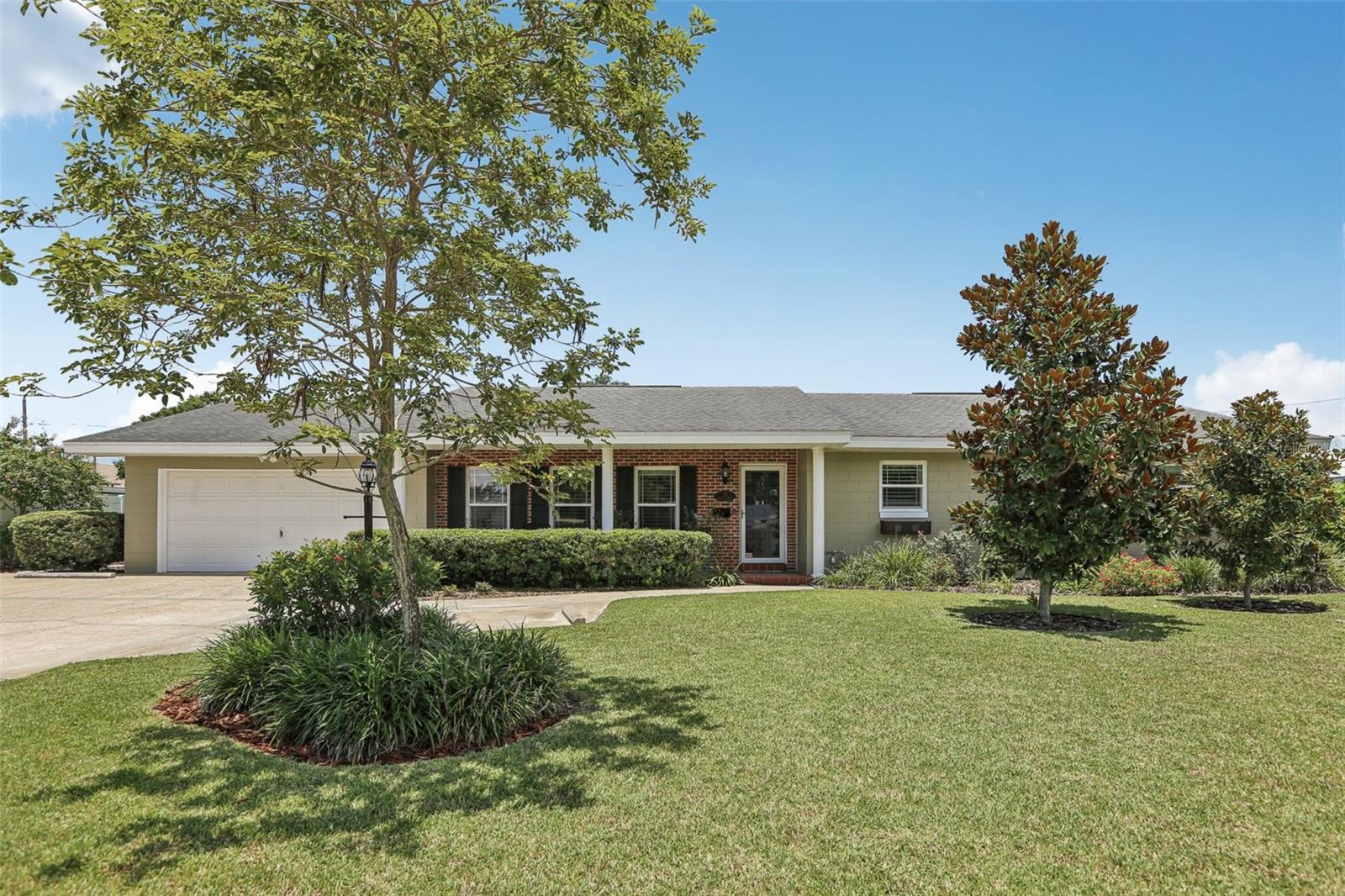 One or more photo(s) has been virtually staged. Welcome to your next chapter in this charming, well-loved home just minutes from the vibrancy of downtown Winter Haven. Tucked into a welcoming neighborhood with no HOA, this home has character, comfort, and plenty of room to stretch out. Inside, you’ll find warm hardwood floors, plantation shutters, and quality Pella windows throughout. There’s even a versatile bonus room under A/C—perfect for a workspace, hobby nook, or extra pantry. Enjoy Florida evenings on your screened back porch, with a handy adjacent storage room and extra half-bath setup. Out back, you’ll discover a sunny butterfly garden, fruit trees (lemon, bananas, lime, mango, mulberry, avocado, olive, and fig), and even your own pineapple patch—plus an irrigation system that runs off a private well, keeping your water bill low. Updates include a fresh exterior repaint (June 2025), new bathroom fixtures, ceiling fans, and brand-new carpet in the family room. Roof and A/C have been professionally evaluated and maintained, with inspections already completed. The AC unit is under a manufacturer's warranty through May of 2027. The hot water heater was installed in 2022 and has a warranty until 10/2028. A detached workshop with electric and thoughtful touches throughout makes this home feel ready for what’s next.