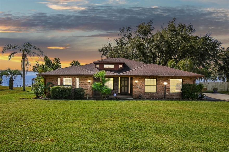 LOCATION LOCATION LOCATION....This Cozy Lakefront Estate sits on Lake Agnes, in a quiet neighborhood with quick access to I-4 leading to Tampa or Orlando . No HOA. Mature landscaping is showcased throughout the .63 acre property. The lush irrigated lawn leads down to a peaceful white-sand waterfront and private boat dock. This fully-fenced backyard oasis is ready to entertain your guests, year-round. Custom built in the early 1990's, this brick home is centrally positioned on the property, allowing for a large front yard, backyard, and an oversized driveway. It features 3 bedrooms, 2 interior full bathrooms, and over 3,000 under-roof square feet. The split-floor plan provides a secluded primary bedroom retreat, with a spa-like ensuite, and 2 large walk-in closets. Four separate sliding-glass doors lead to a screened lanai, with a picturesque view overlooking the lake. This home is well-lit with windows and light fixtures perfectly placed throughout. The eat-in kitchen offers tons of countertop space, as well as cabinetry. The bright spacious living area has a vaulted ceiling and a wood burning fireplace. The large laundry room and utility room sit right off of the 2 car garage. A whole-house generator was recently installed in 2023. Just 3 houses down on the left, there is a boat ramp where you can launch close to home. Don't miss this opportunity!!! Schedule your private showing, today!